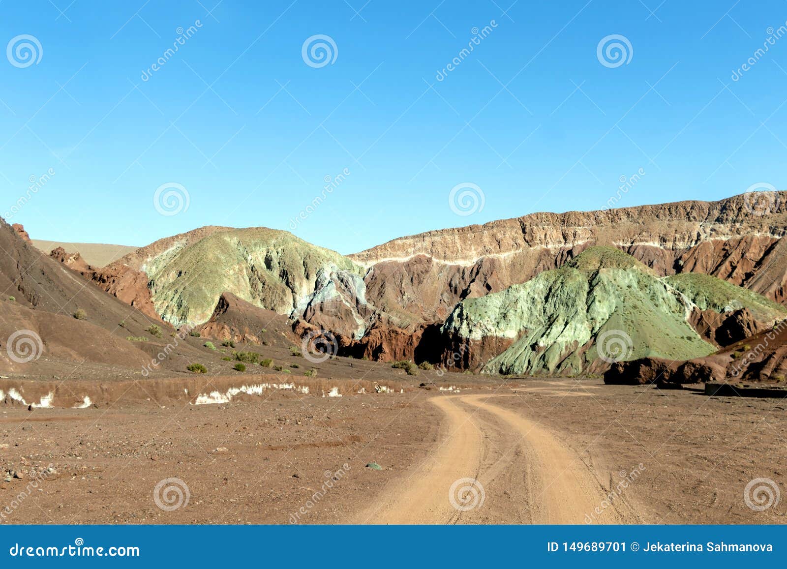 road in the rainbow valley valle arco-iris in the atacama desert of chile, south america