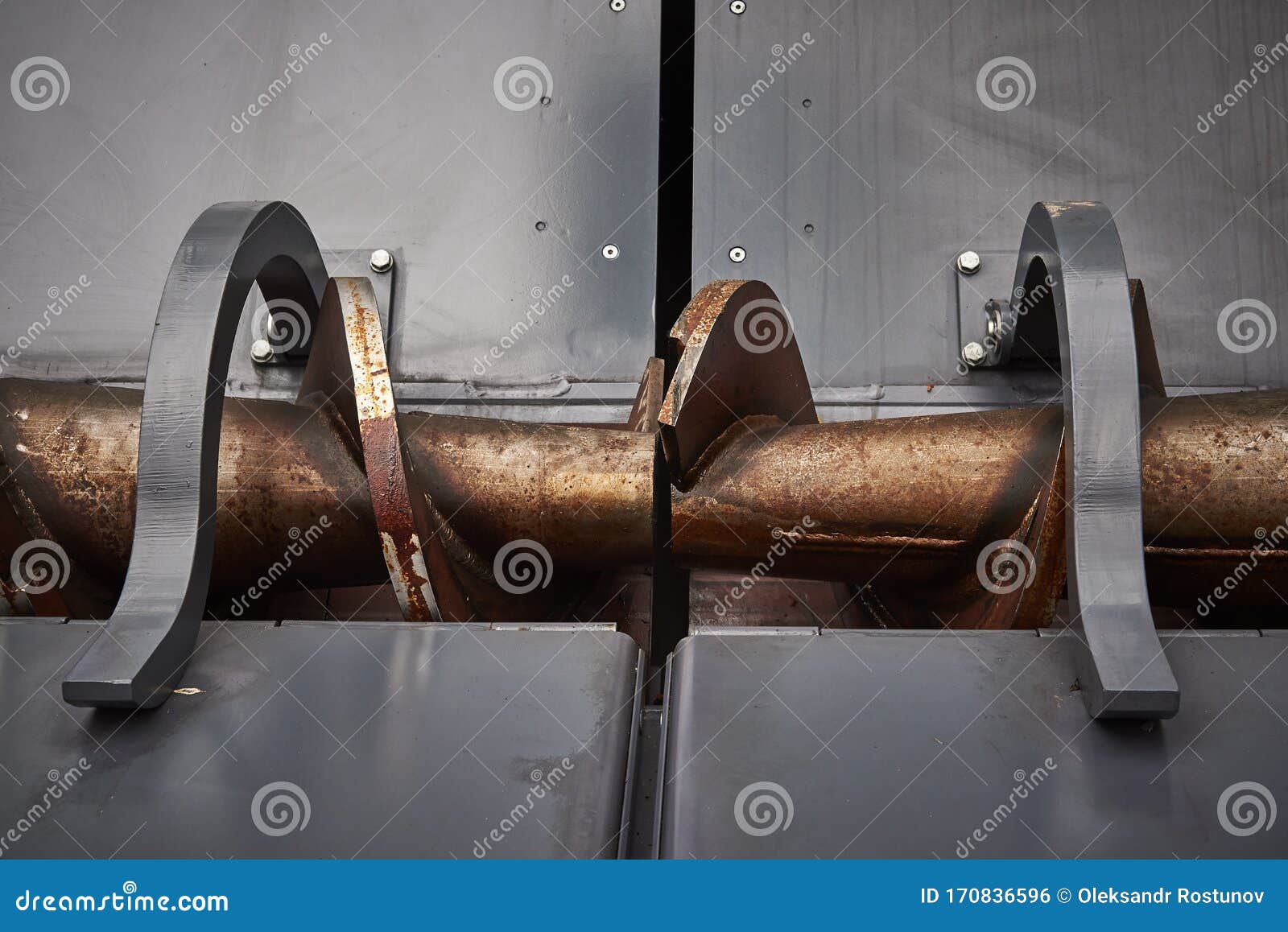 Road Construction Machinery. Asphalt Feed Auger in Paver Hopper Stock