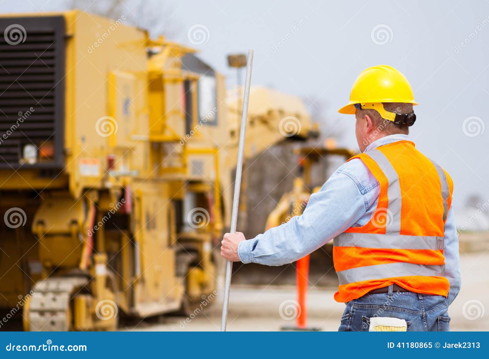 Road highway construction worker with equipment and machinery in the background