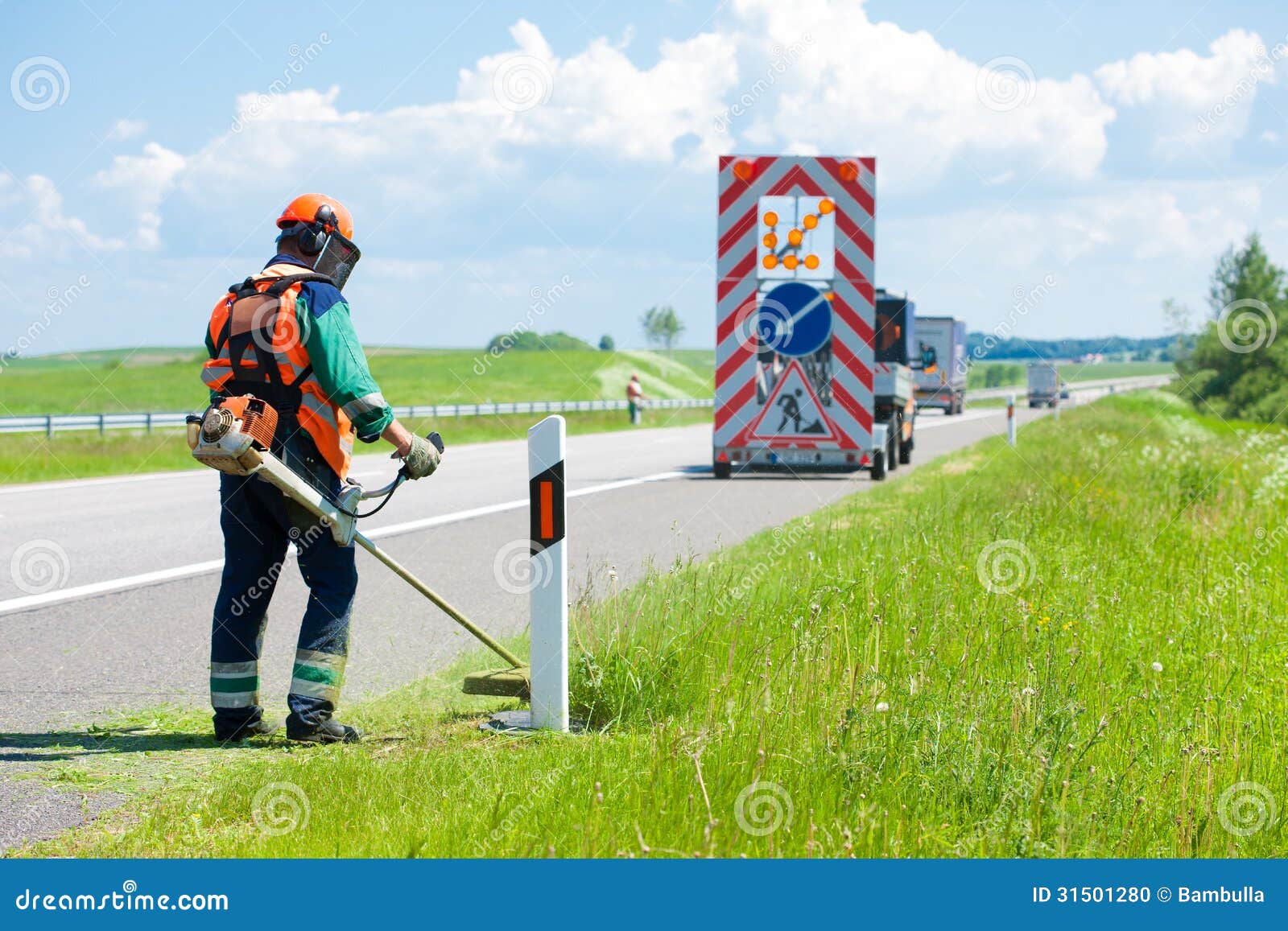 Road Landscapers Cutting Grass Around Mileposts Stock Photo Image