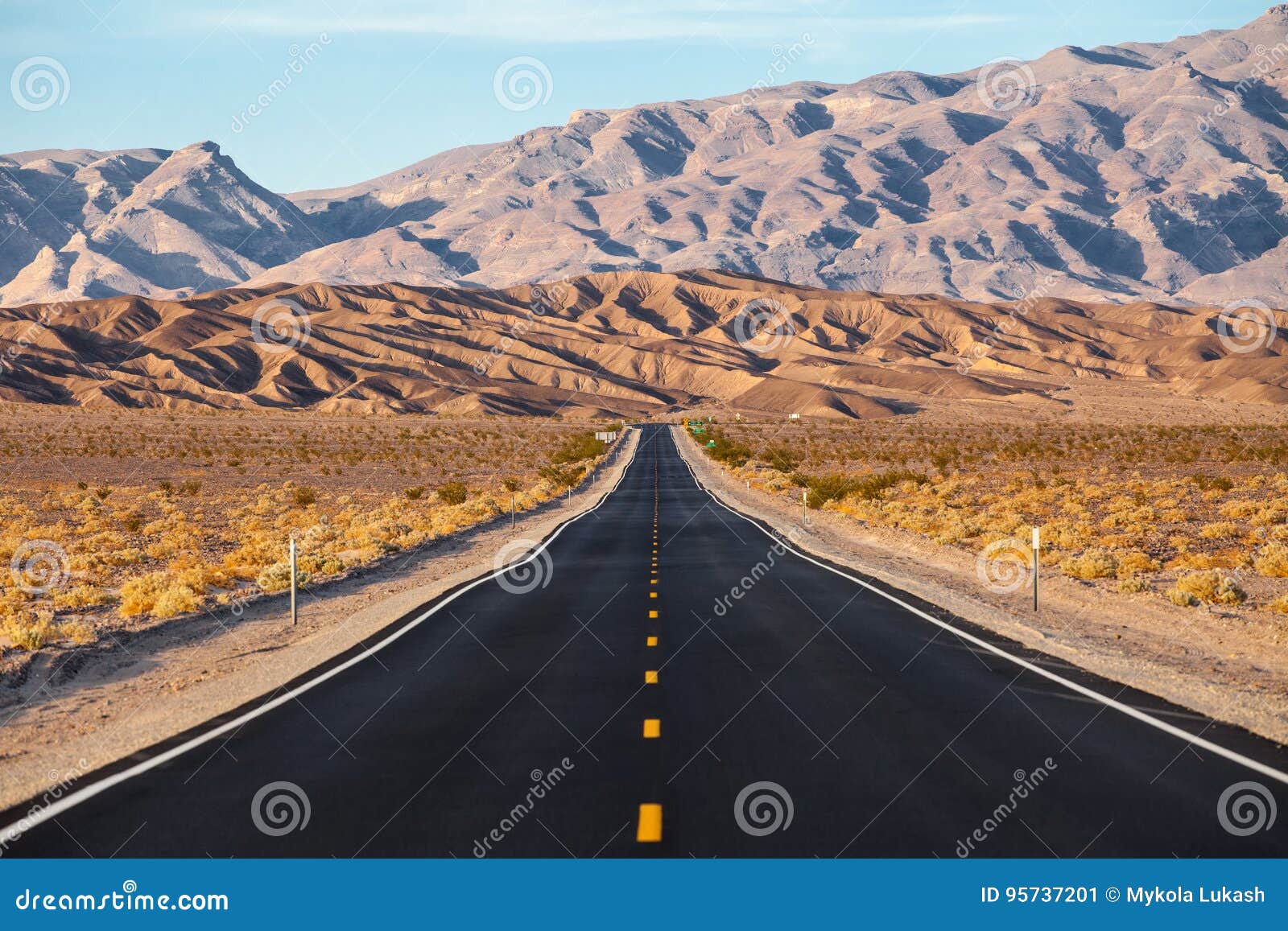 a road runs in the death valley national park, california, usa