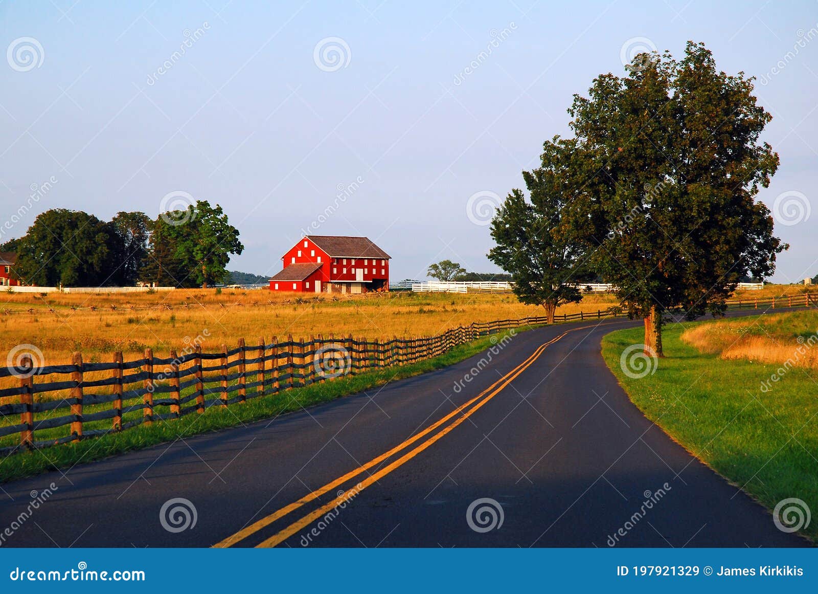 a road traverses bucolic countryside