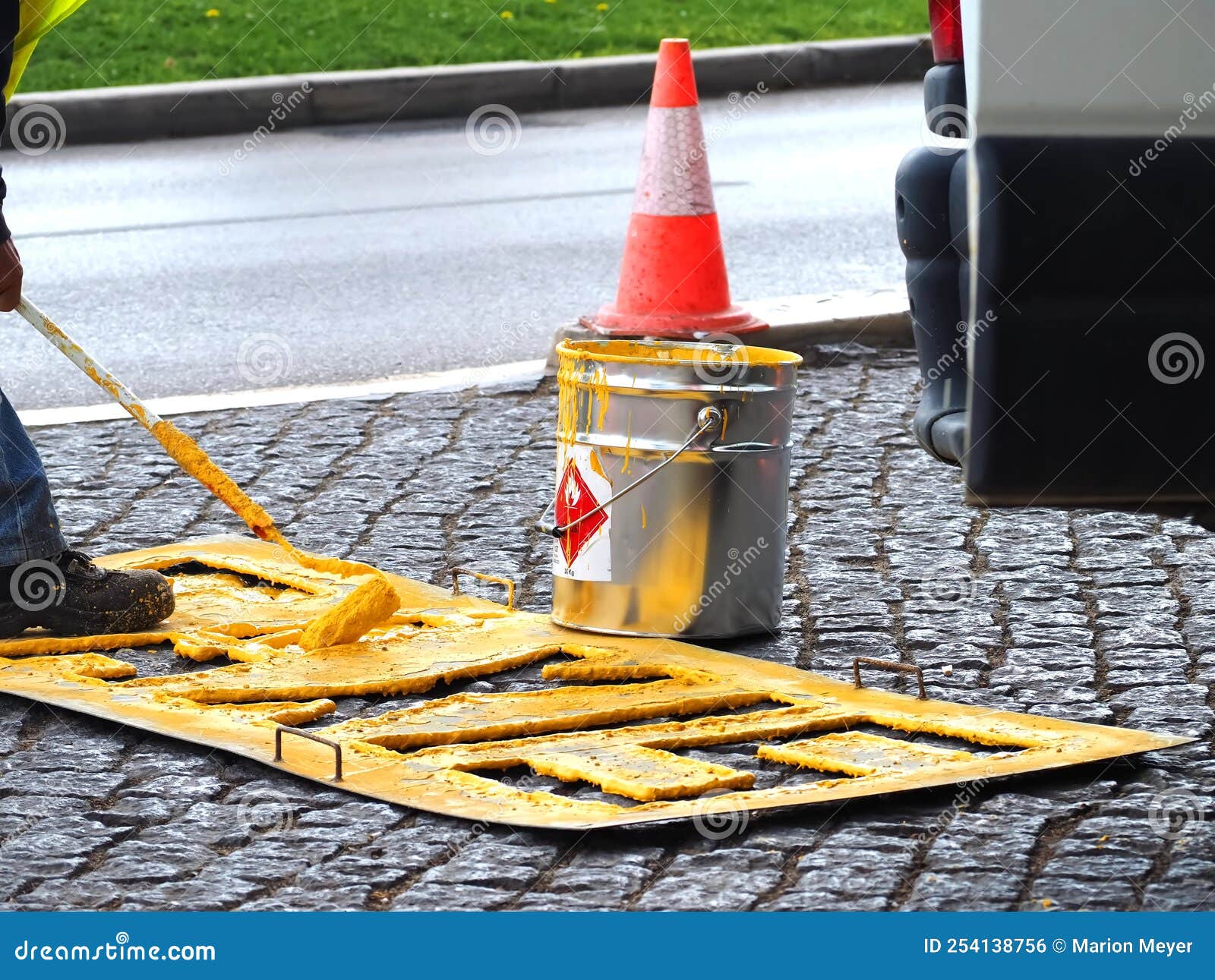 road workers paint lane markings for taxis with yellow marcas viales color in portugal