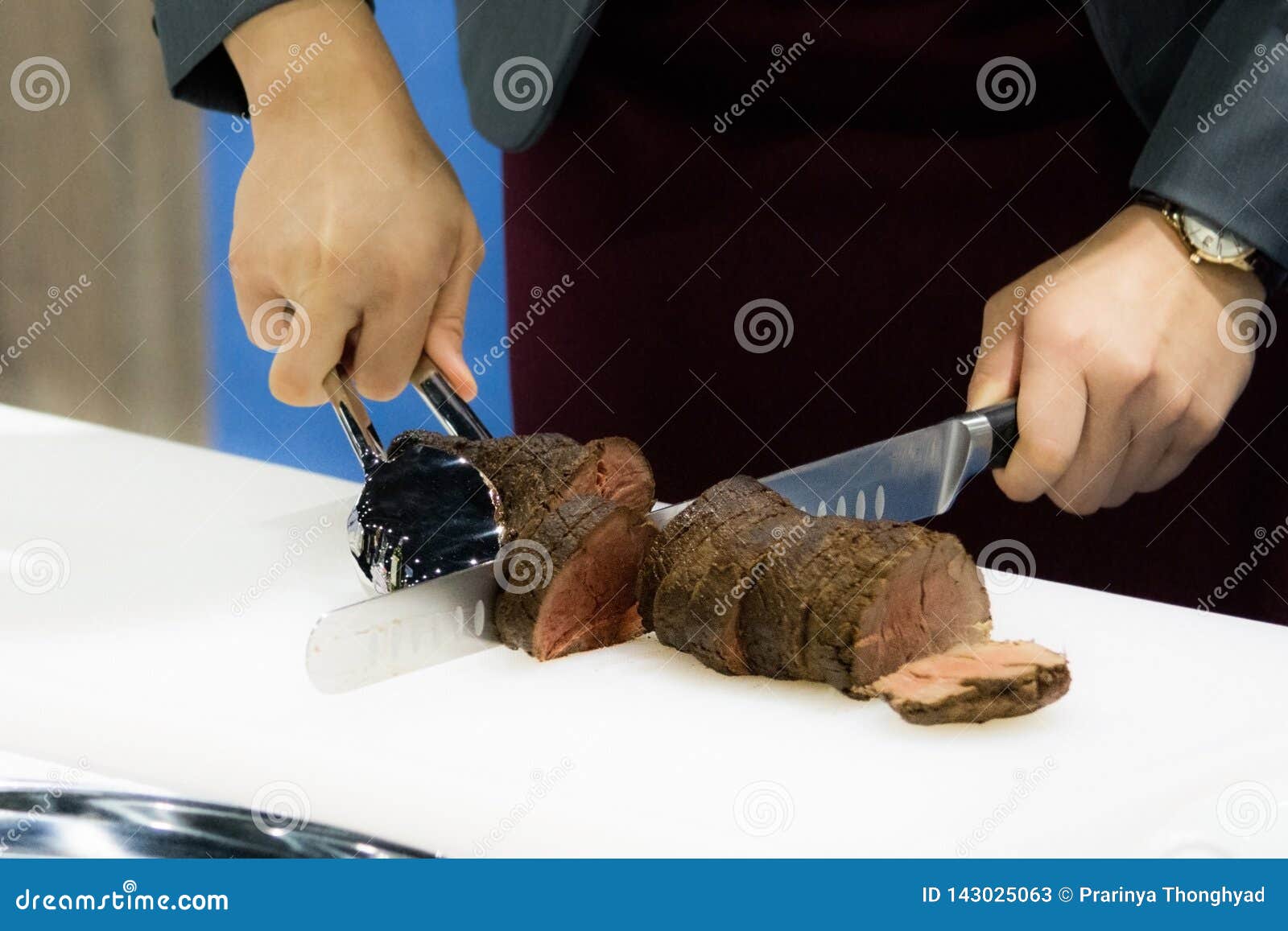 roast beef and slice, chef `s hands cutting roast beef, carving roast beef