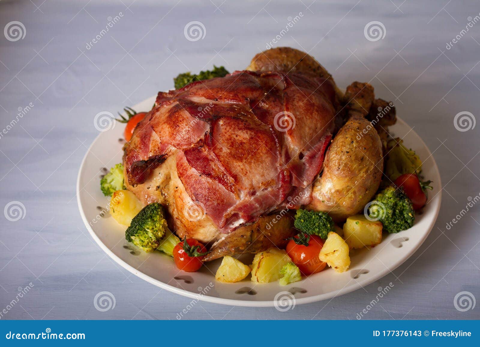Roast Chicken with Breasts Wrapped in Bacon and Vegetables. Stock Image