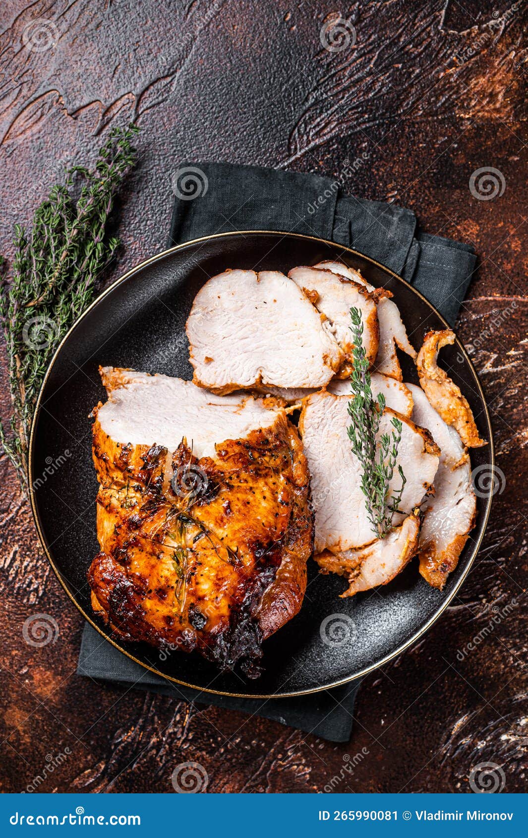 Roast Rolled Pork Ham Meat on Plate with Thyme. Dark Background Stock