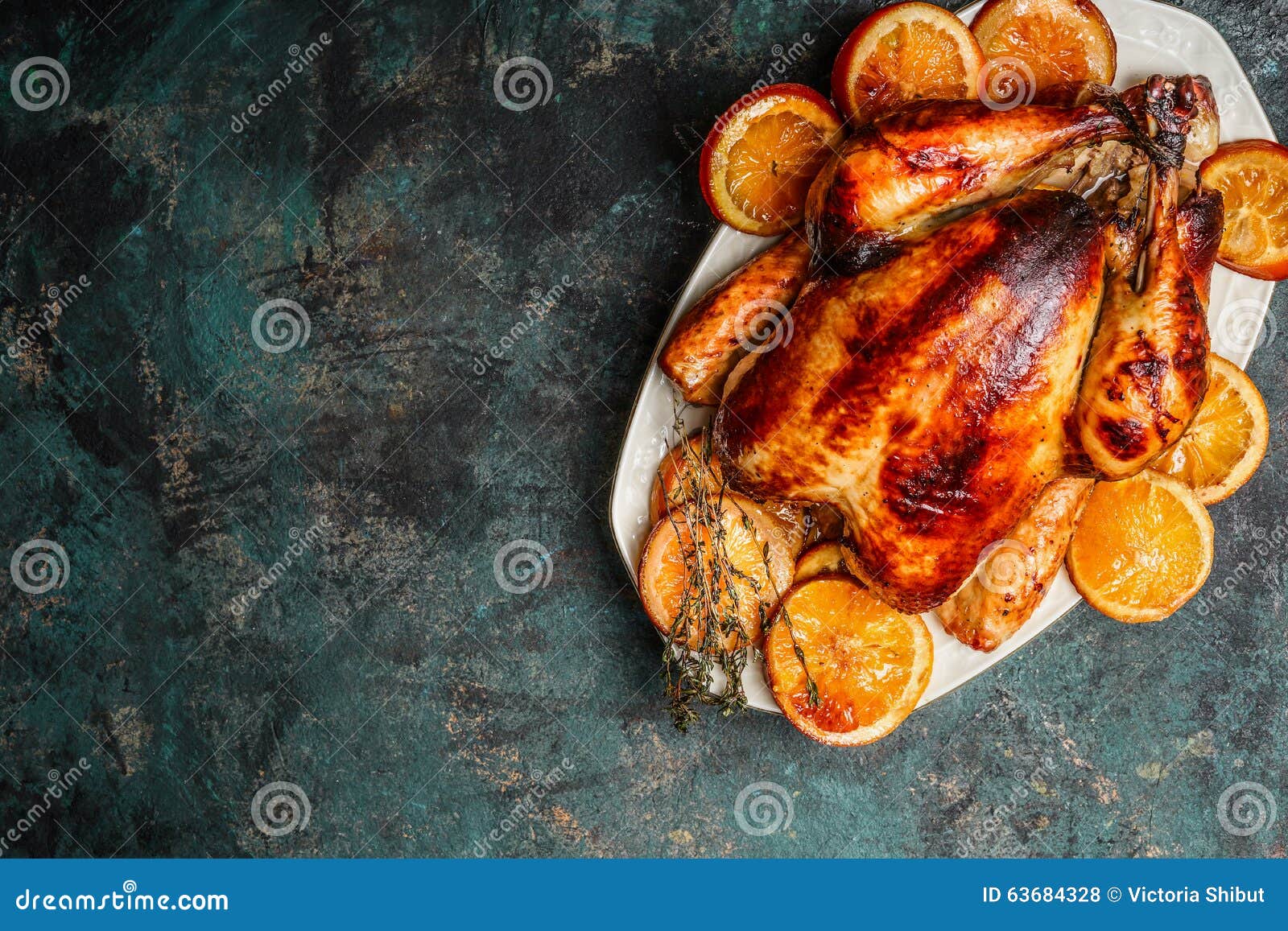 Roast Whole Turkey or Chicken in Plate with Roasted Oranges on Dark