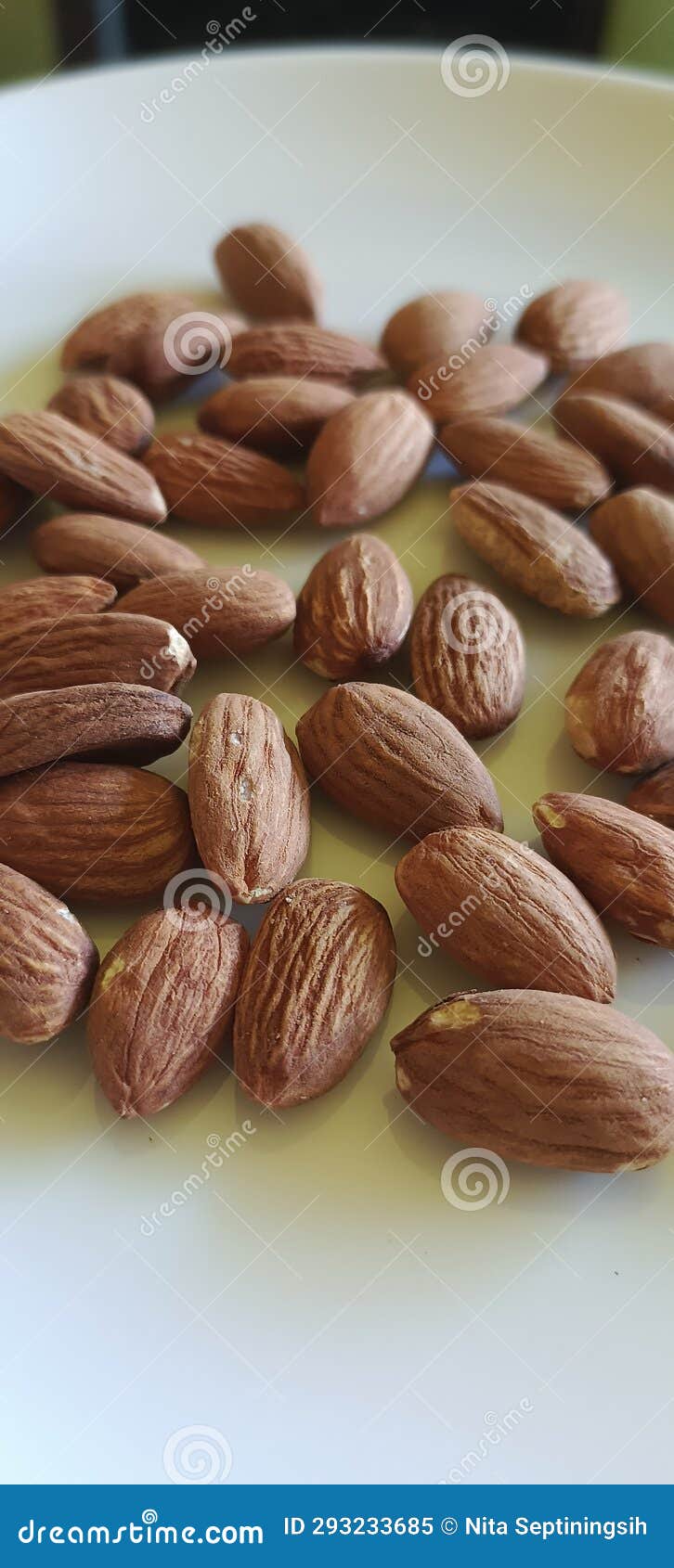 Roasted Almonds on a White Plate and are Good for Bone Health Stock