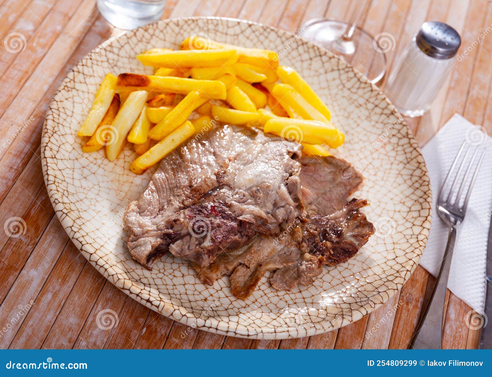 Roasted Bone-in Pork Chop with Crispy French Fries Stock Image - Image