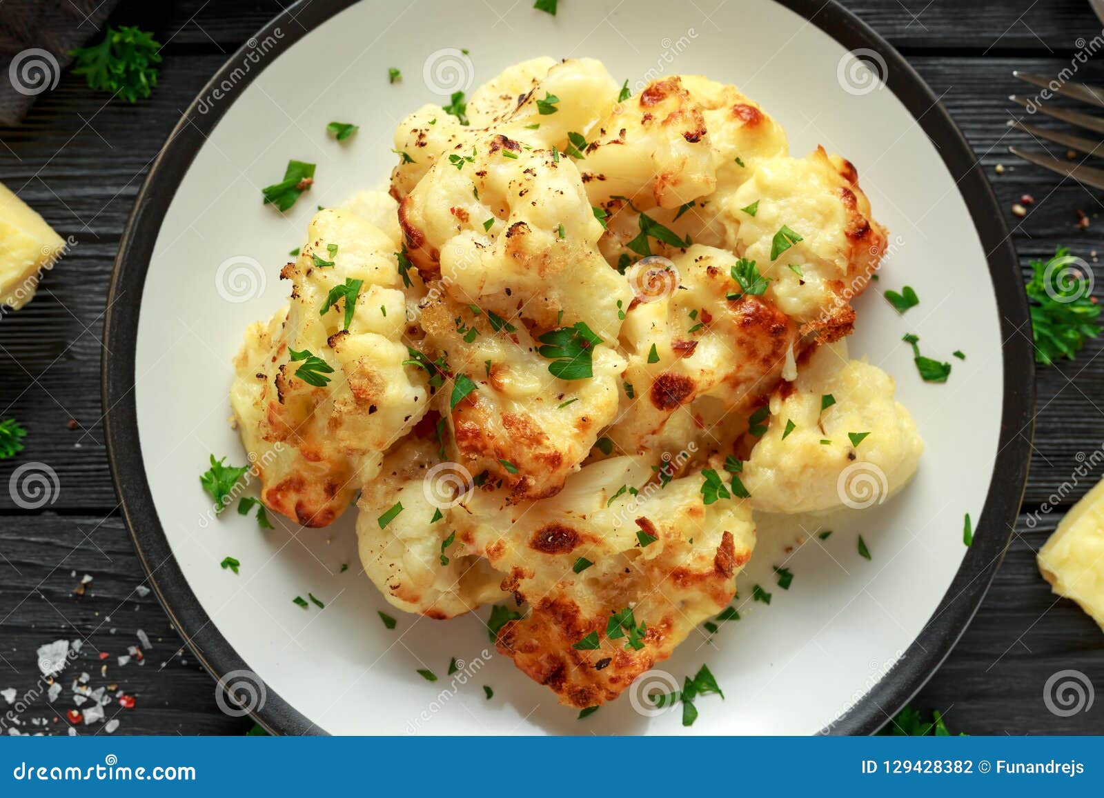 Roasted Cauliflower with Cheddar Cheese Sauce and Herbs. Stock Photo