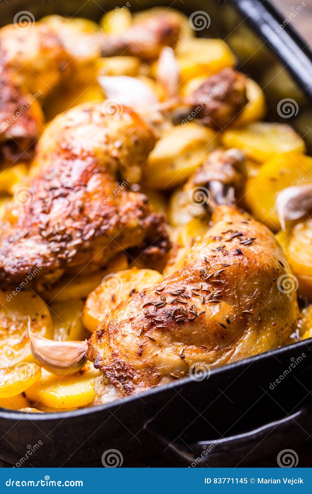 Roasted Chicken Leg with Potatoes with Caraway and Garlic Stock Image