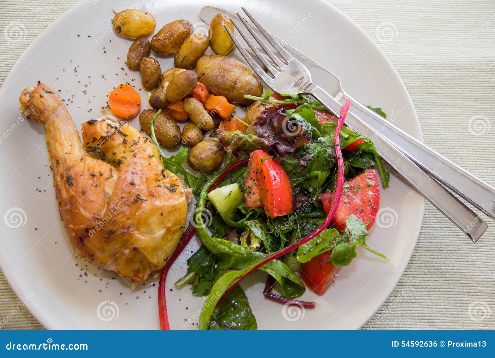 Roasted Chicken Leg, Potatoes and Vegetable Salad Stock Photo Image