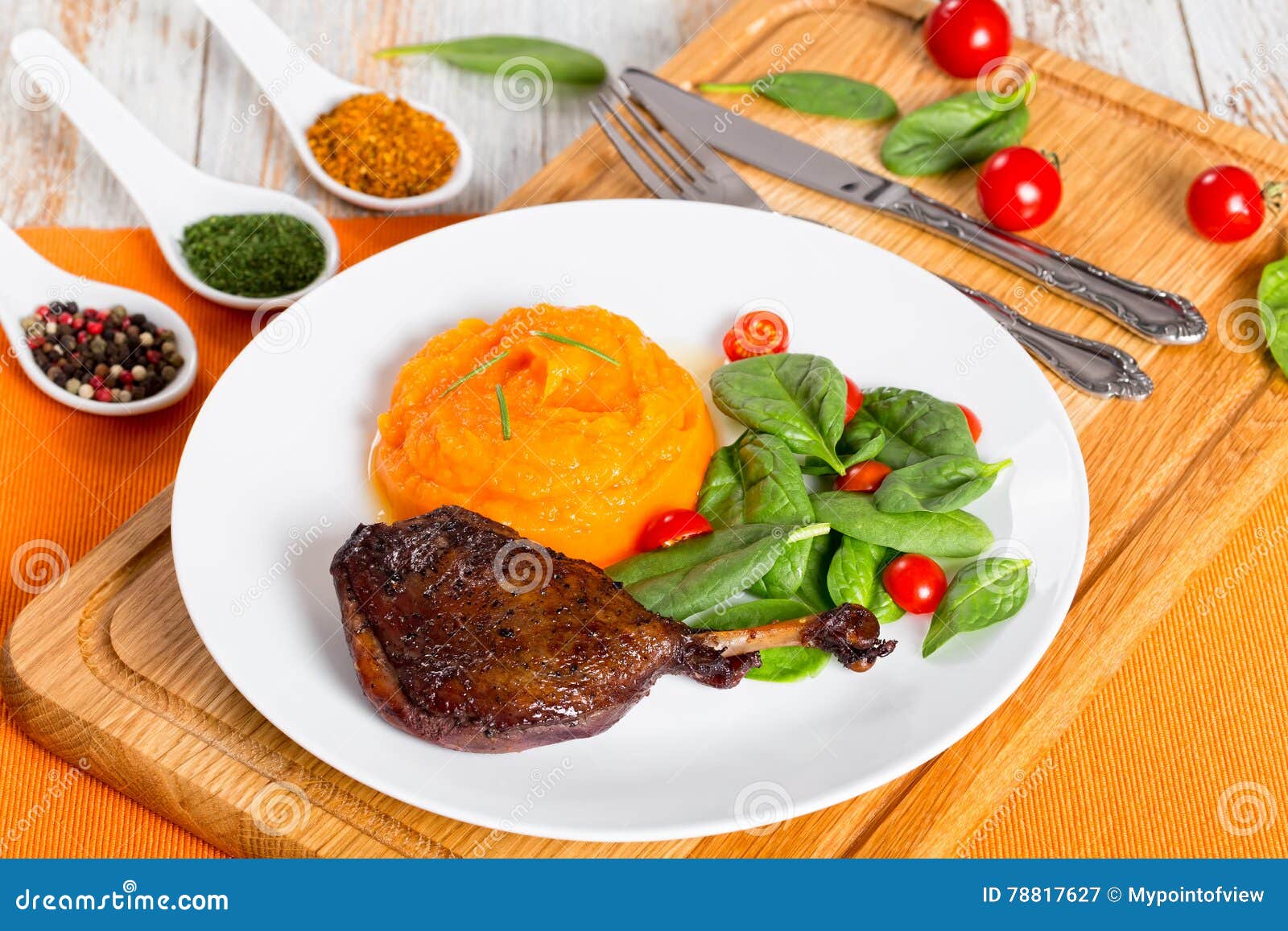 roasted duck leg with mashed pumpkin and salad