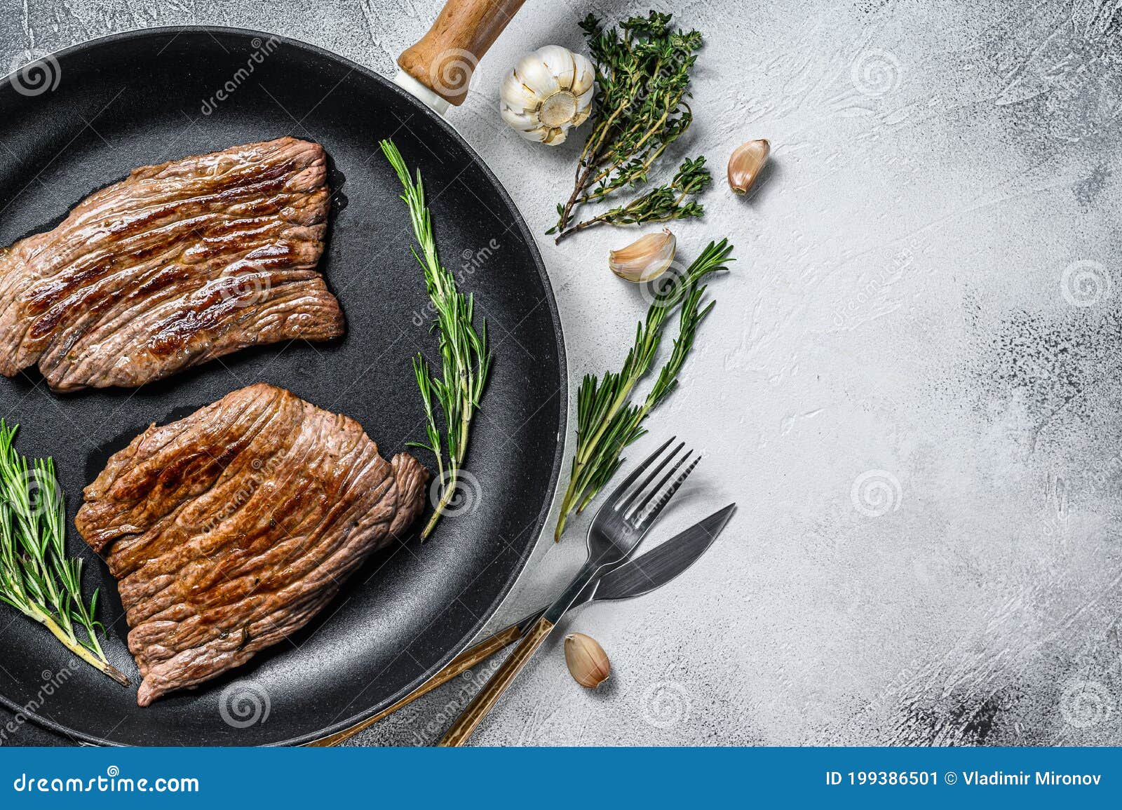 Roasted Flat Iron and Flank Steaks. Marble Beef Meat. Gray Background
