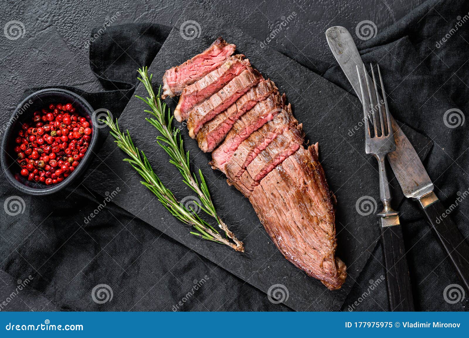 Roasted Medium Rare Sliced Flank Beef Steak. Black Background Stock