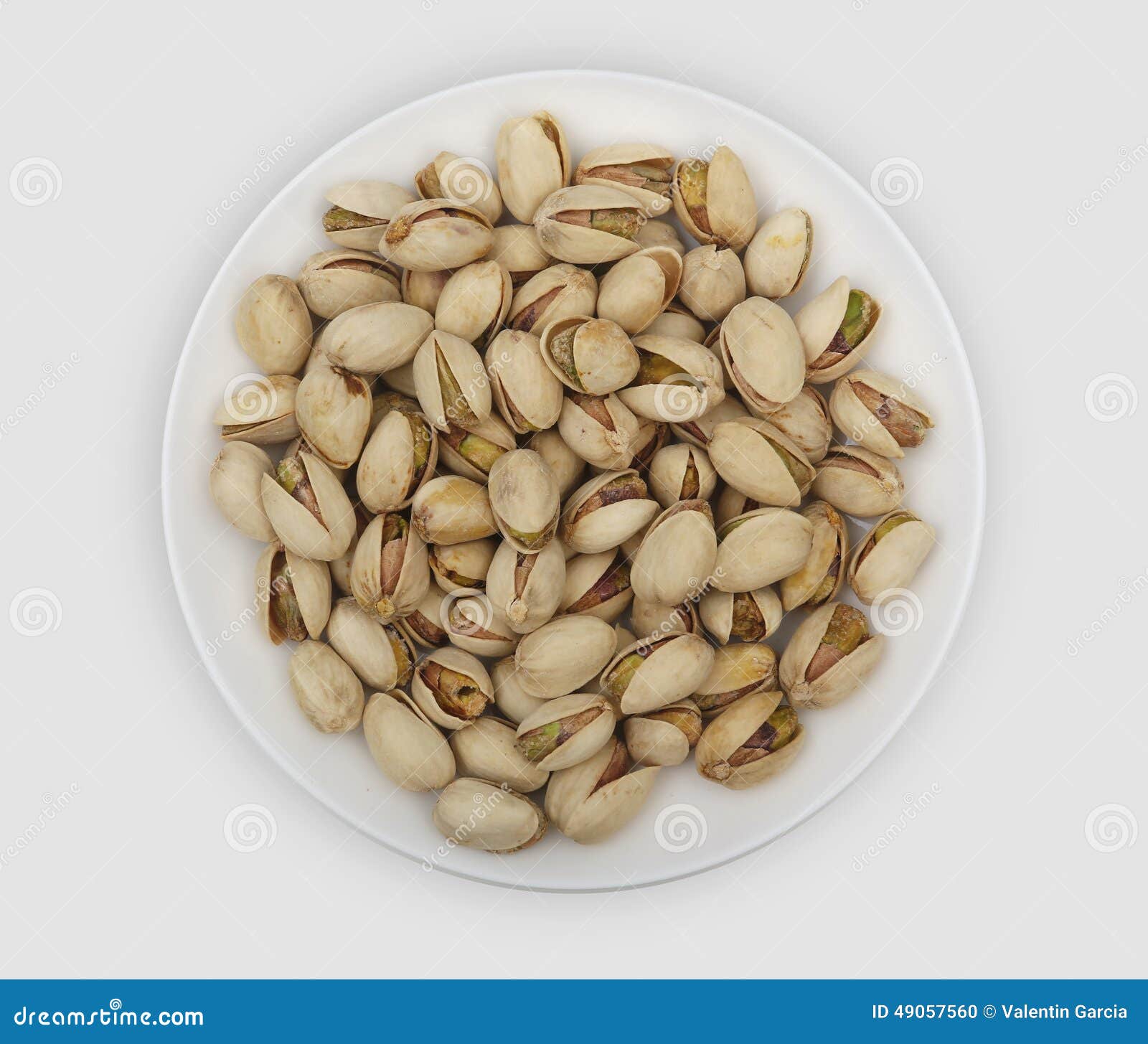 roasted pistachio nuts on a white plate