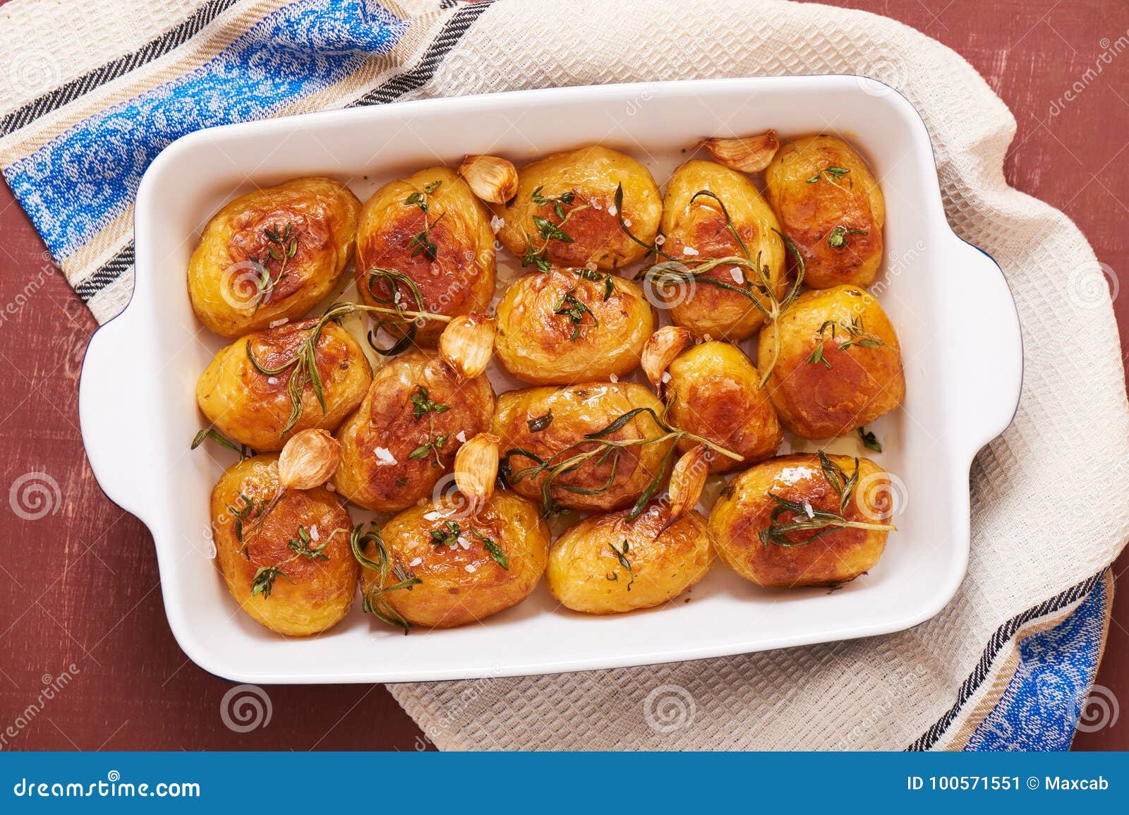 Roasted Potatoes with Garlic, Thyme and Rosemary in Ceramic Baking Dish