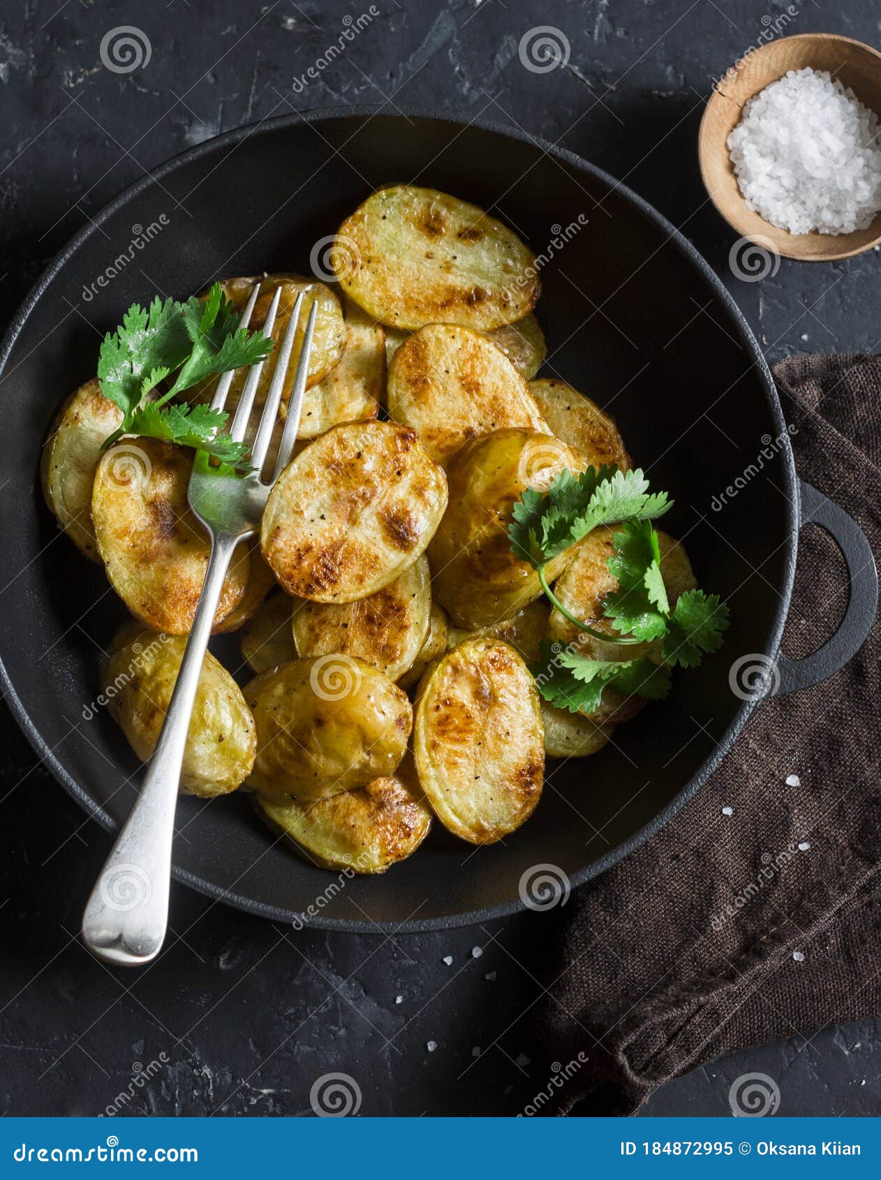 Roasted Young Potatoes in a Cast Iron Skillet on a Dark Background, Top