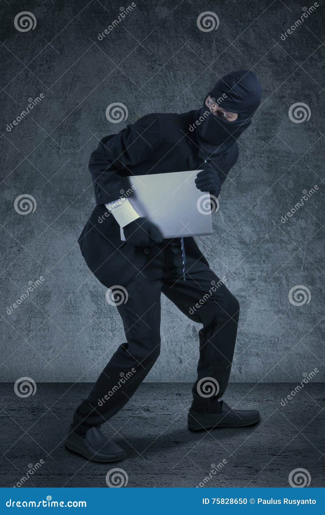 robber stealing notebook computer