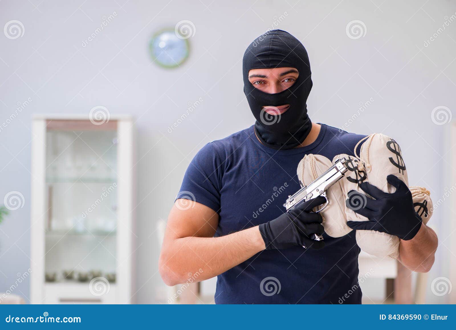 The Robber Wearing Balaclava Stealing Valuable Things Stock Photo