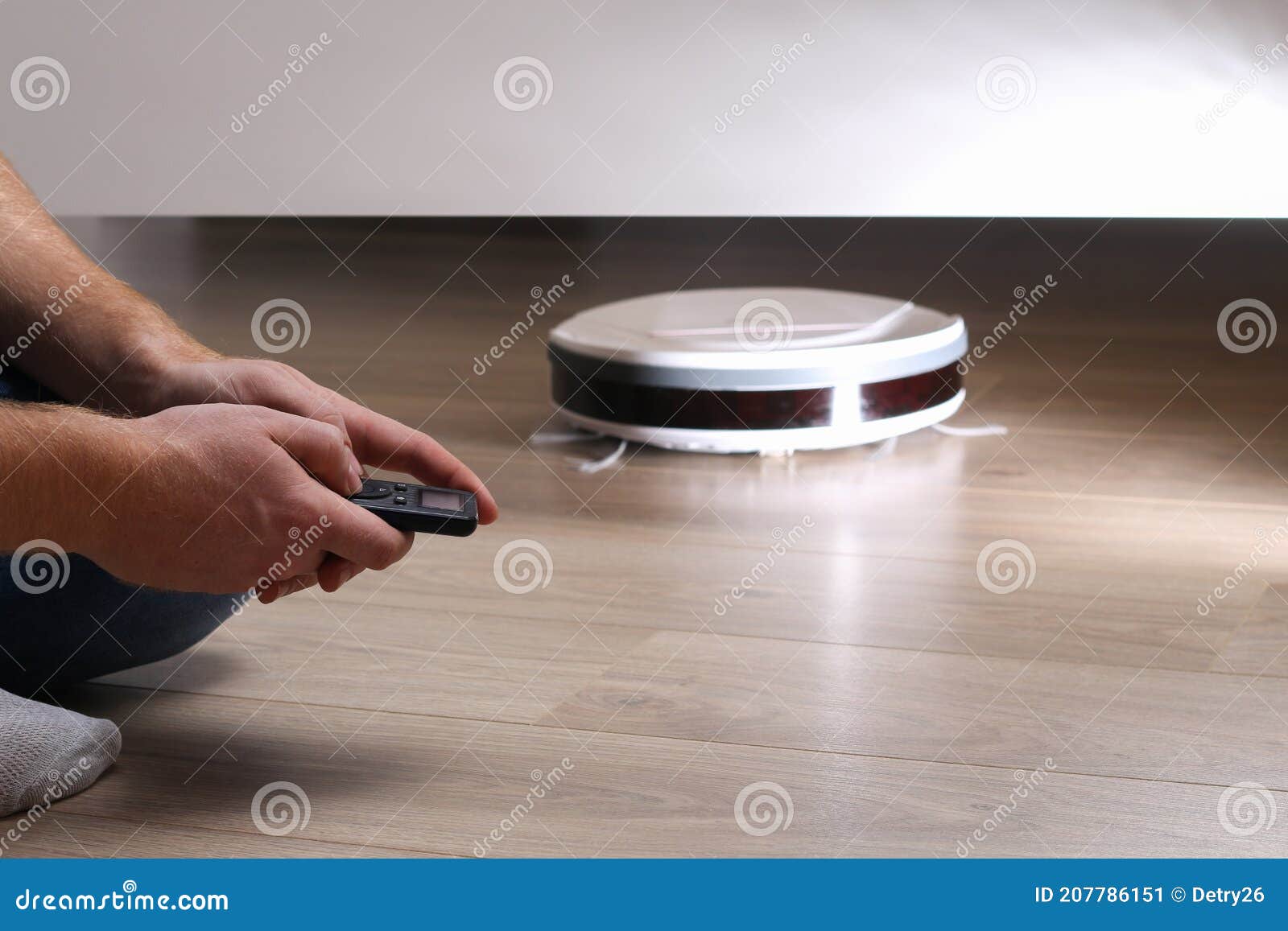 The Robot Vacuum Cleaner Cleans Under Bed. Stock Image Image of