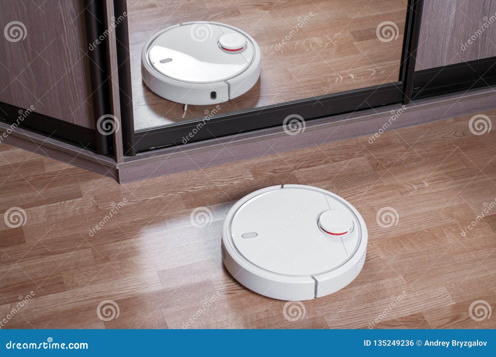 Robot Vacuum Cleaner On Laminate Floor Is Reflected In Mirror Of