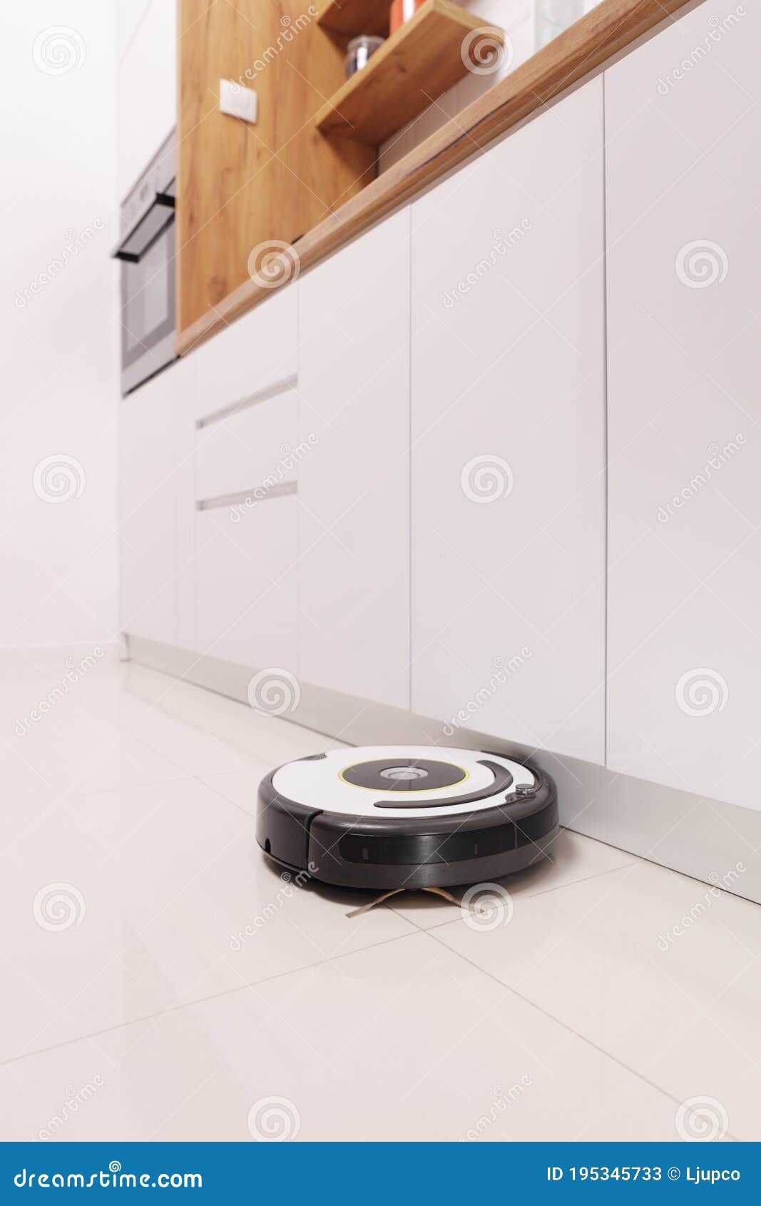 Robotic Vacuum Cleaner Working on a Kitchen Stock Image Image of