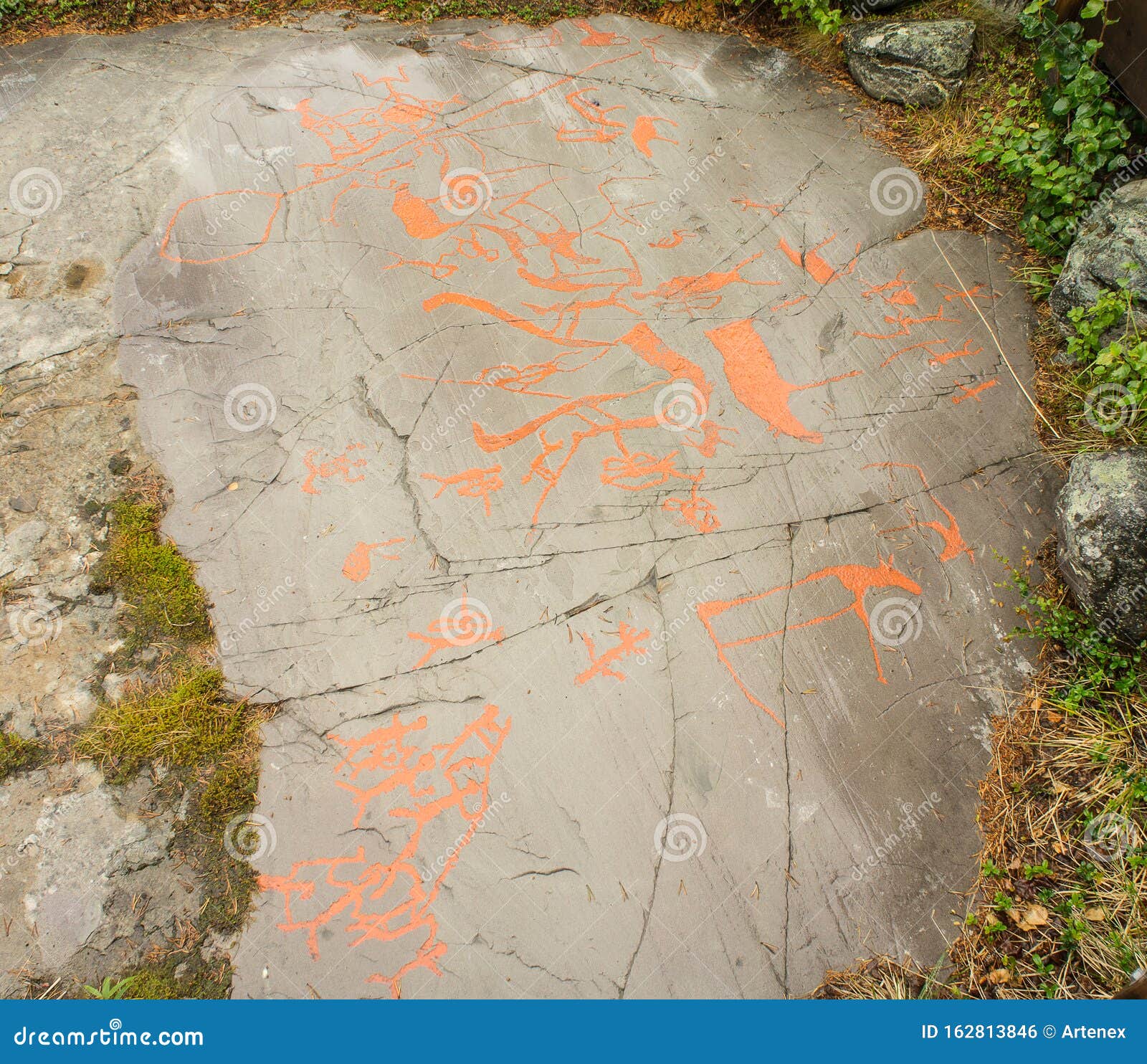 rock art in alta fjord, norway. ancient s, real drawing,  texture in stone. red ocher paint. human preys on animals deer.