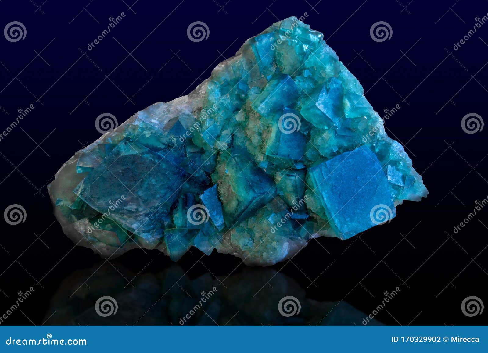 rock of blue calcite mineral on dark background.