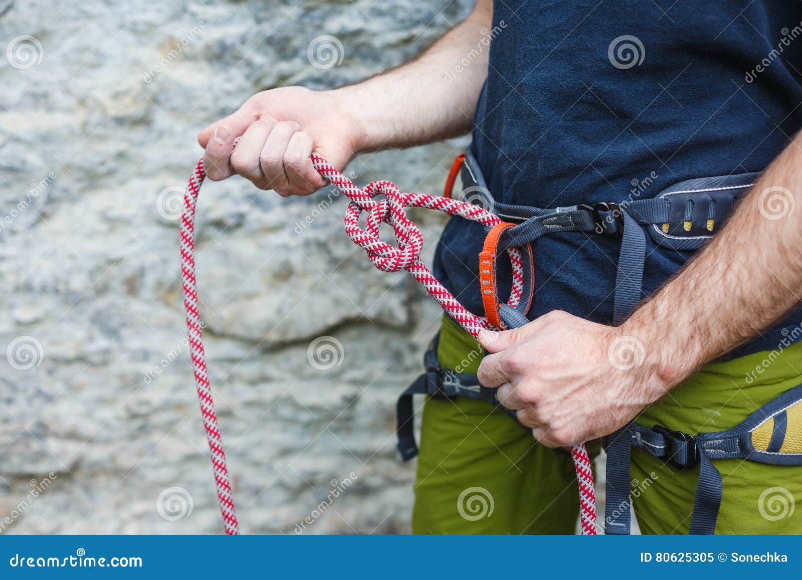 Rock Climber Adjusting Harness by the Rock Face Stock Image Image of