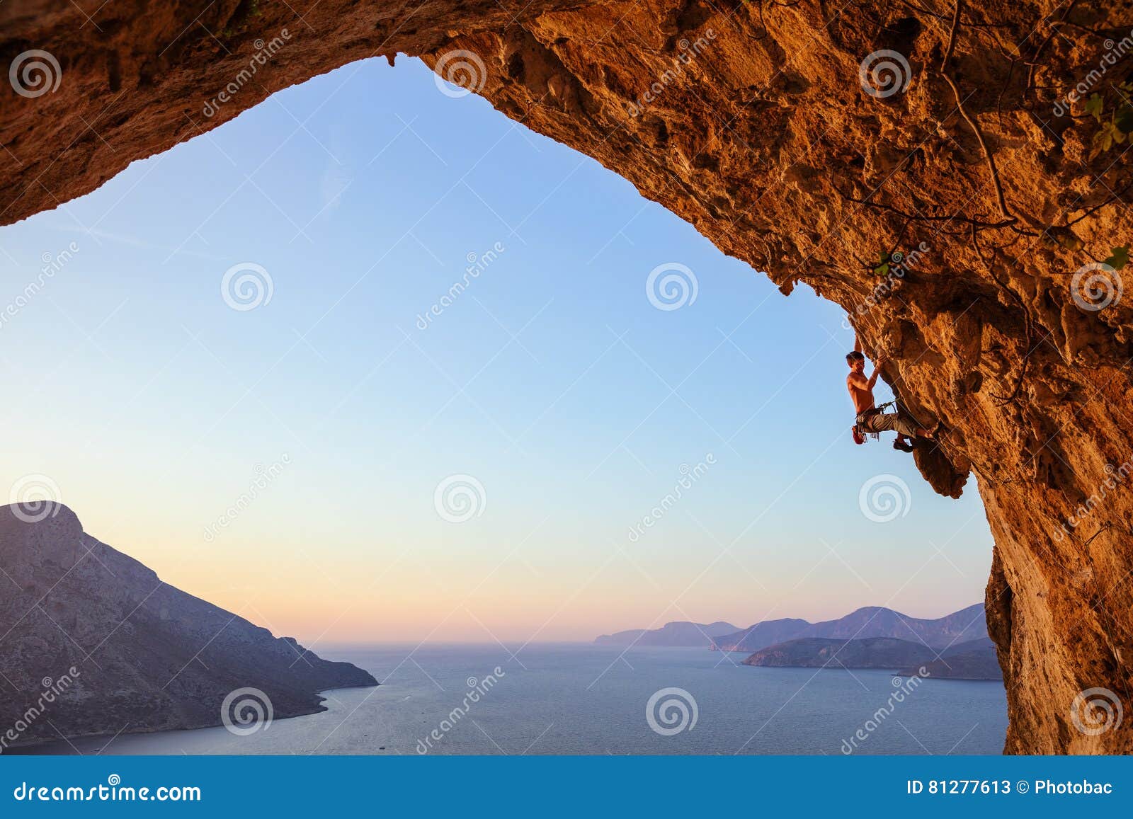 rock climber on overhanging cliff.
