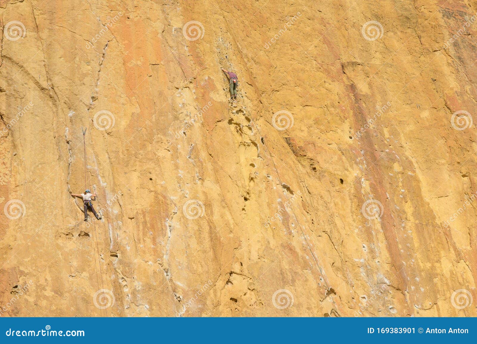 Rock Climbers Climb a Large Rock, Filmed from the Back Stock Image