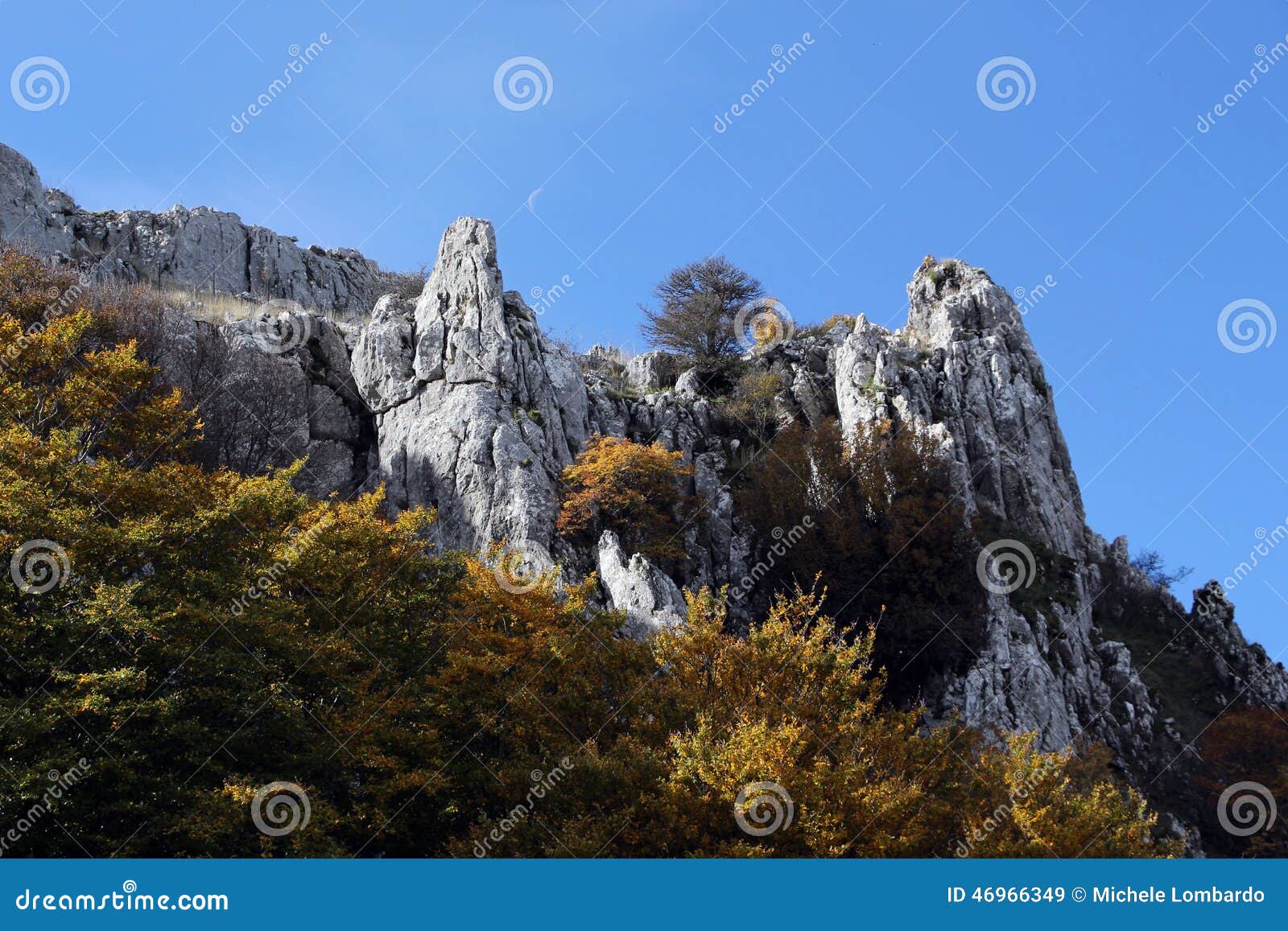 rock outcroppings in autumn, with the moon