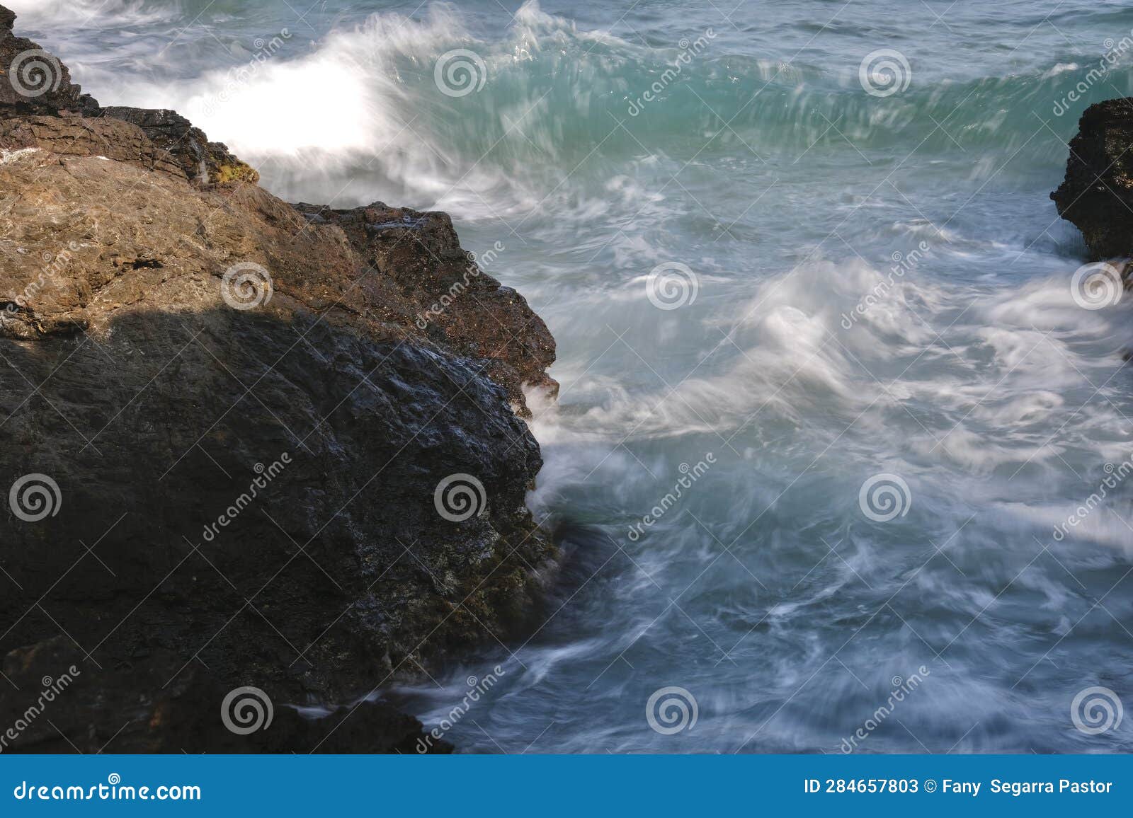 in the rock that protrudes on the coast, the waves collide with it