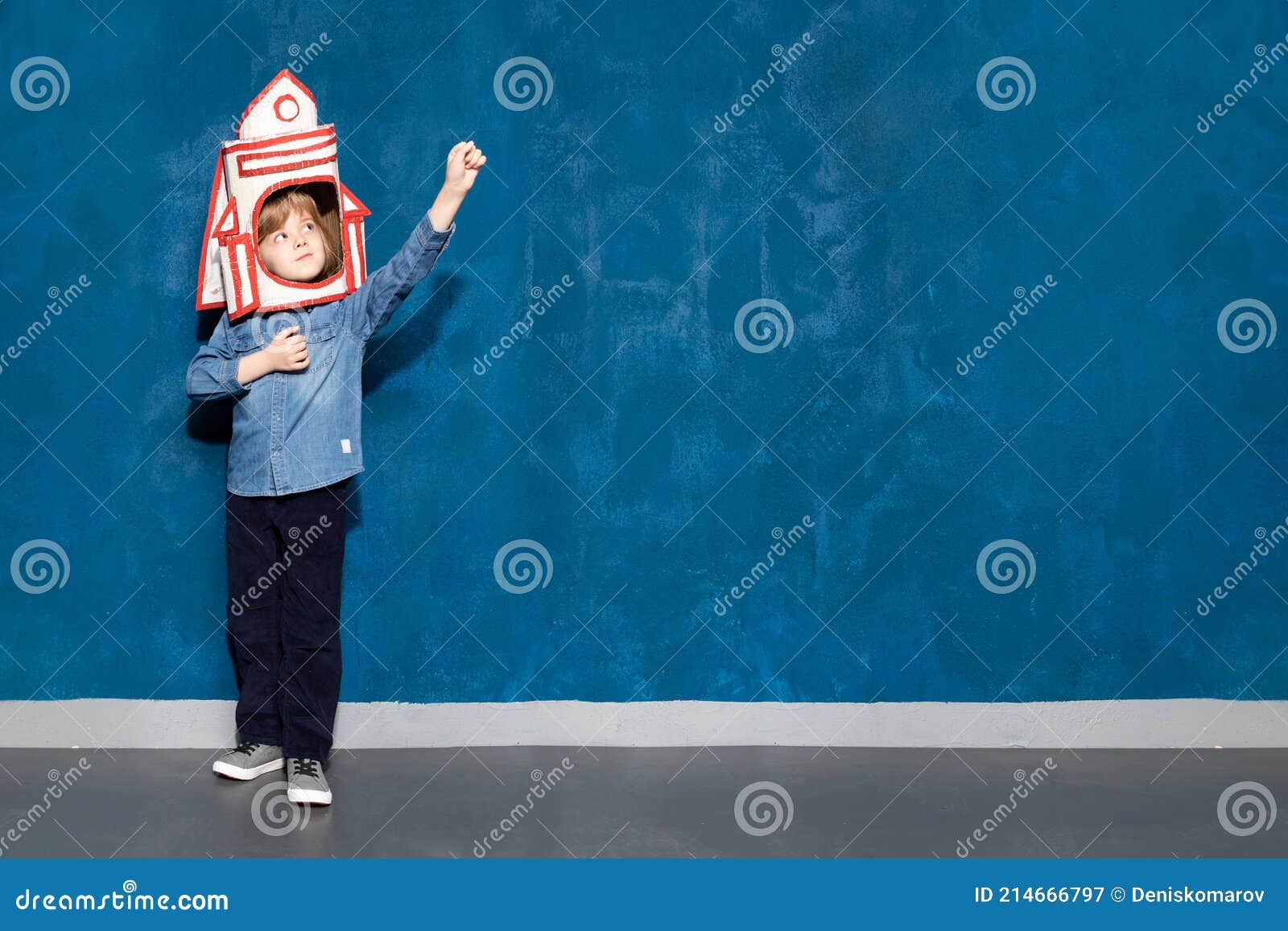 boy kid with toy spacecraft on head showing cosmic flight