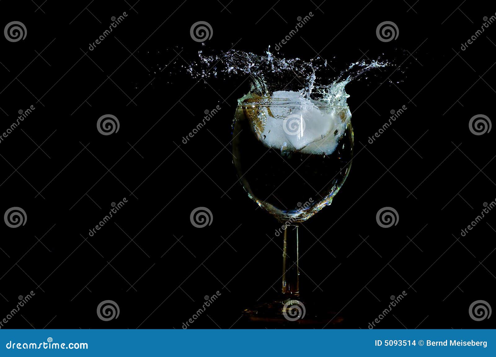 On the Rocks. Ice cube falling in a glass making a big splash