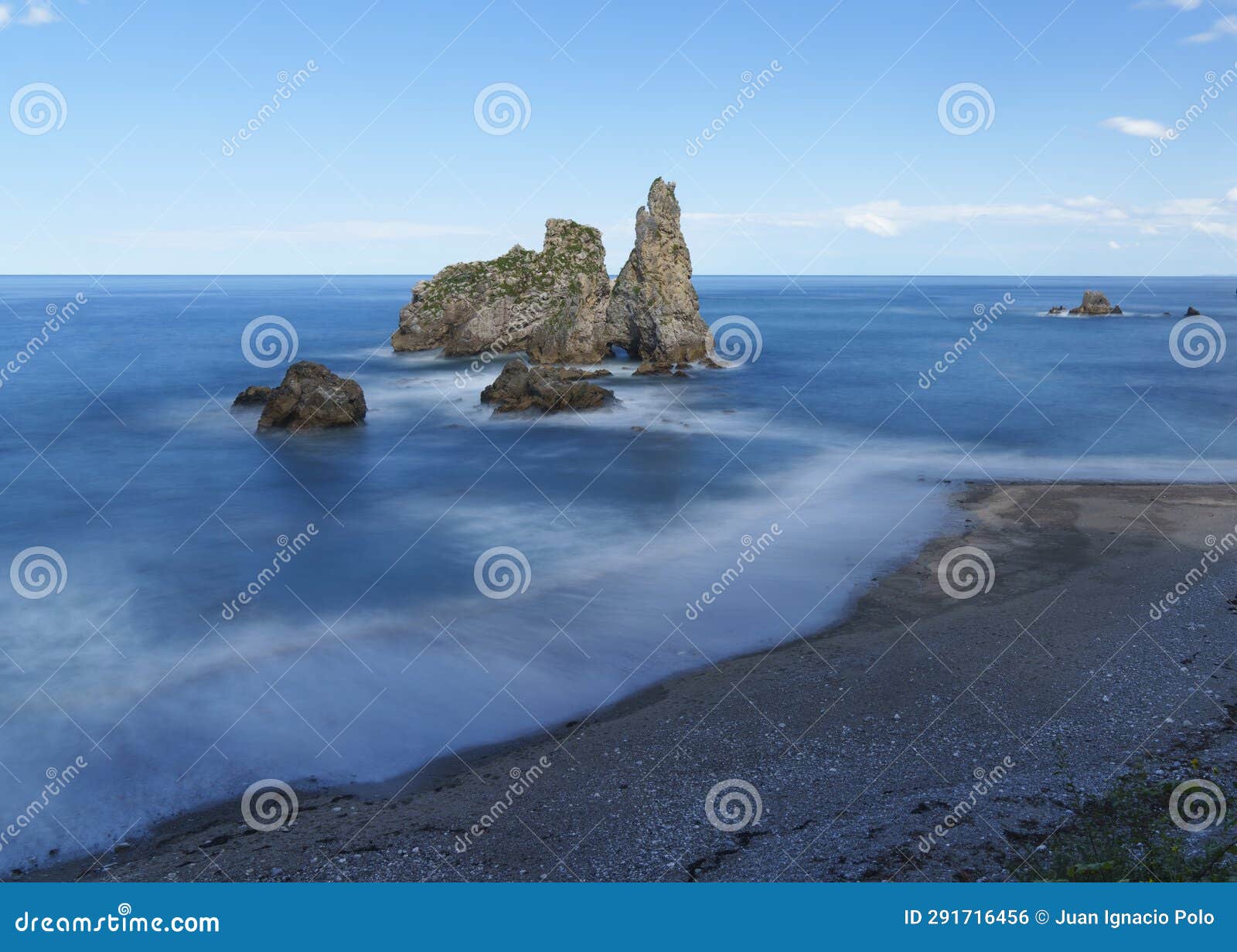 rocks in the blue waters of the cantabric sea, pendueles beach in asturias.