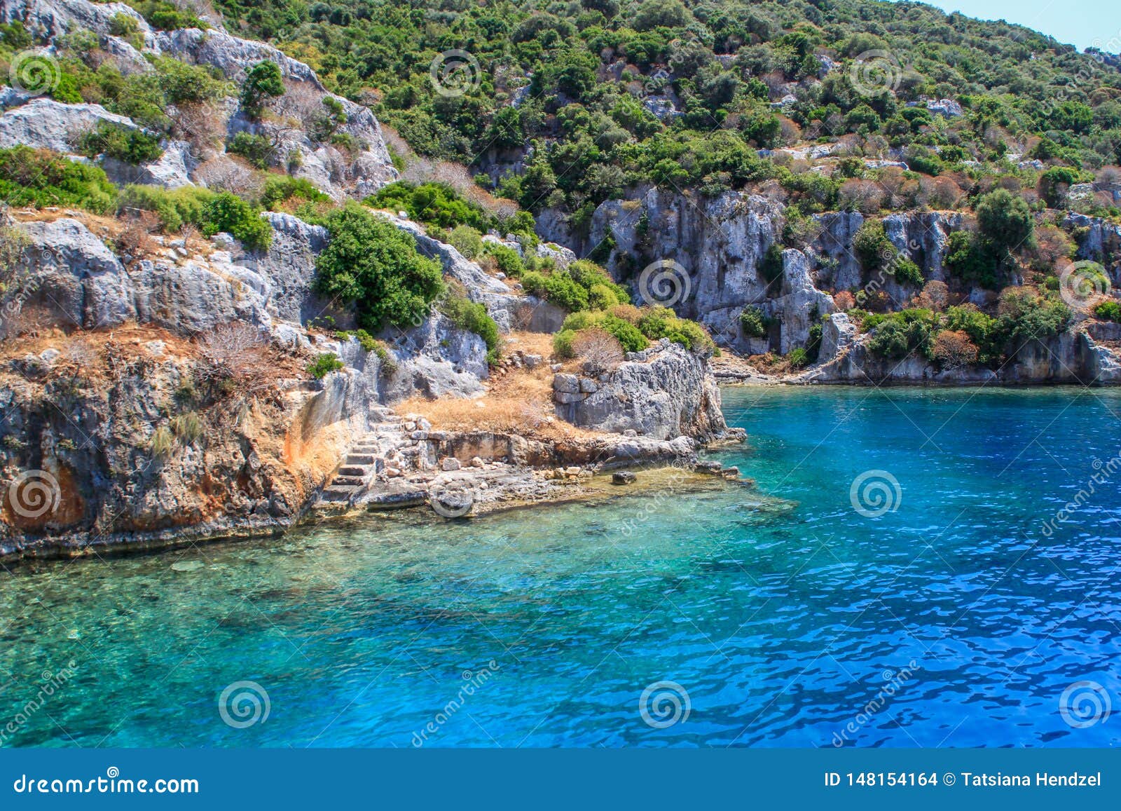 rocks and bright turquoise water in the mediterranean sea. ruins of an ancient city in bodrum