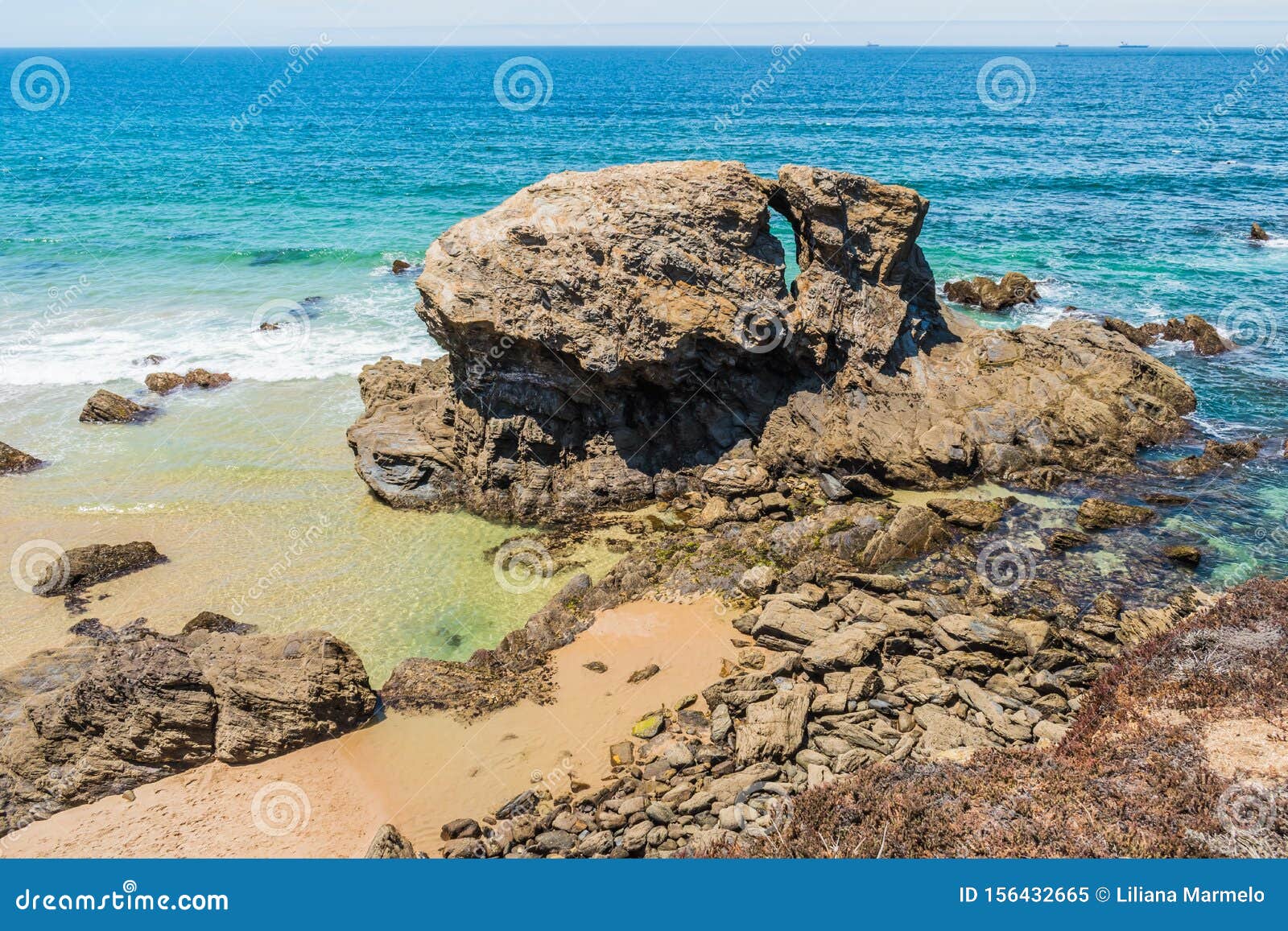 rocks and small natural pools in an idyllic setting on samoqueira beach, porto cÃÂ´vo - sines portugal