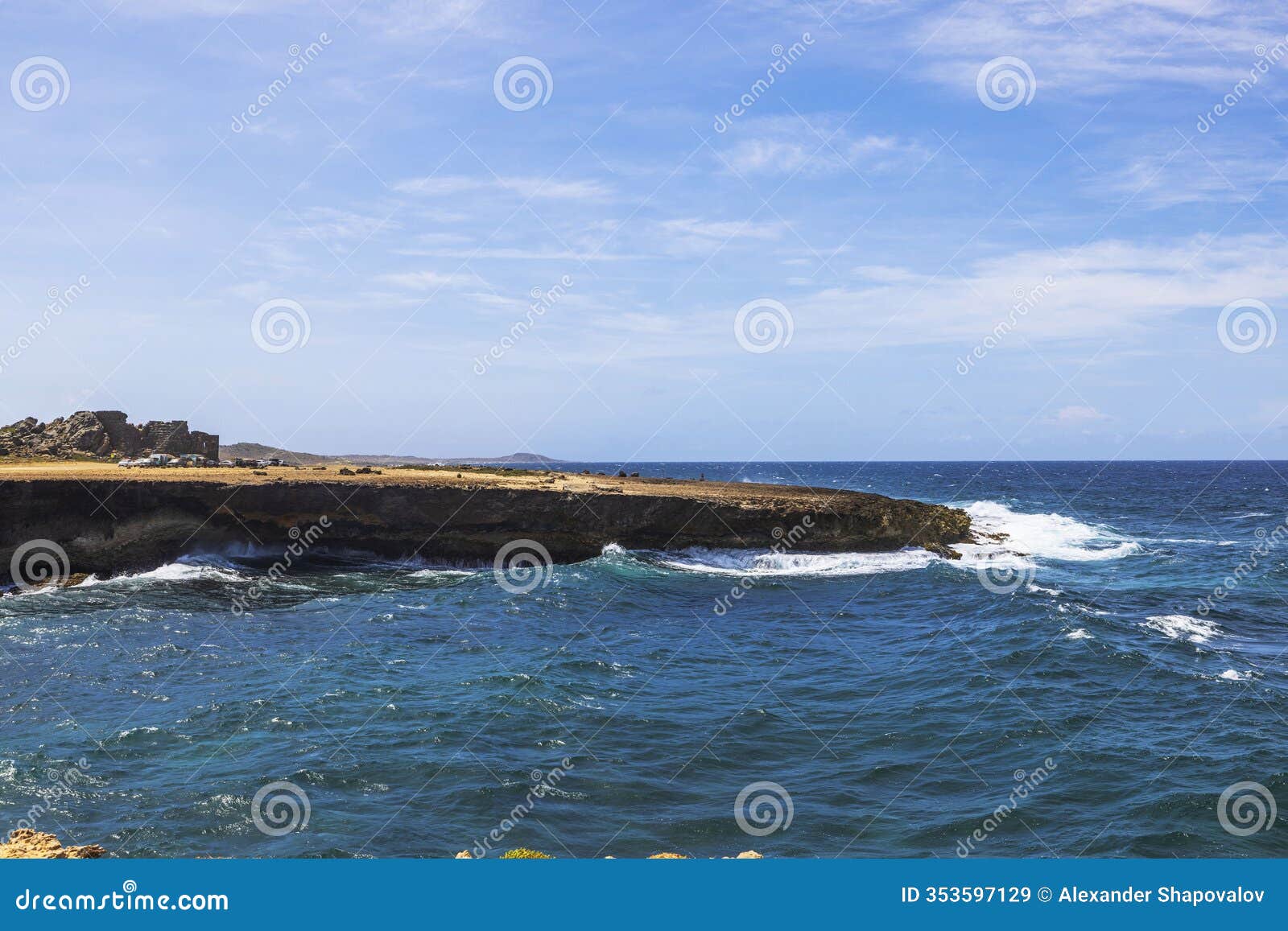 rocky coastline of arikok national park in aruba with turquoise caribbean sea waves crashing