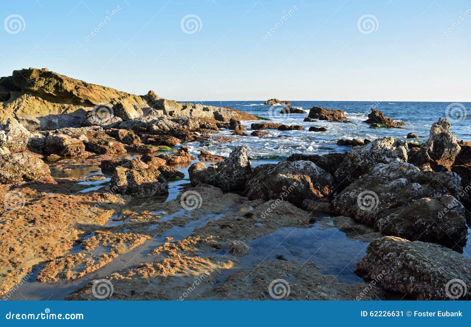 rocky coastline at low tide below heisler park in laguna beach, california.