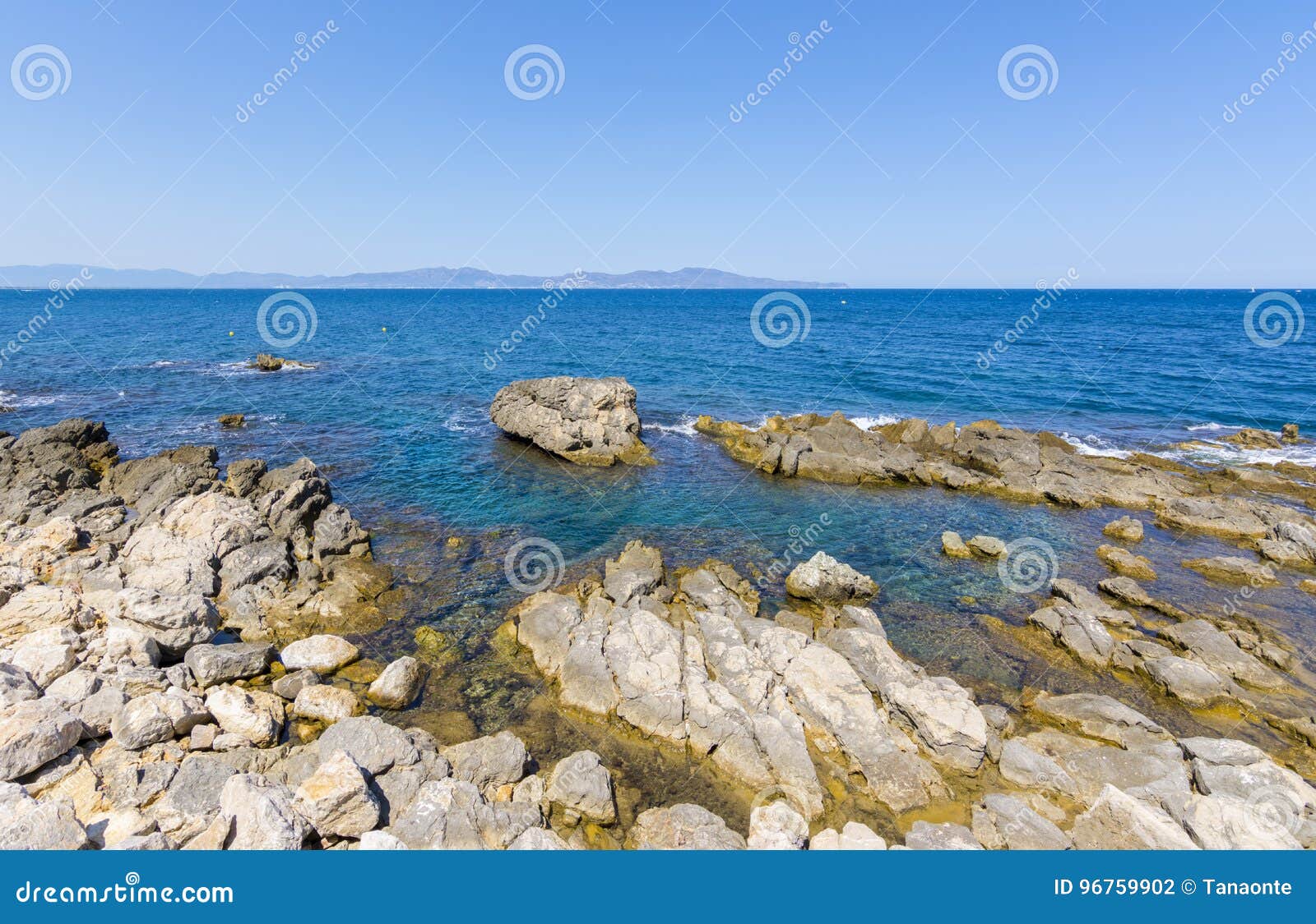 rocky mediterranean coast of l`escala village in costa brava, spain