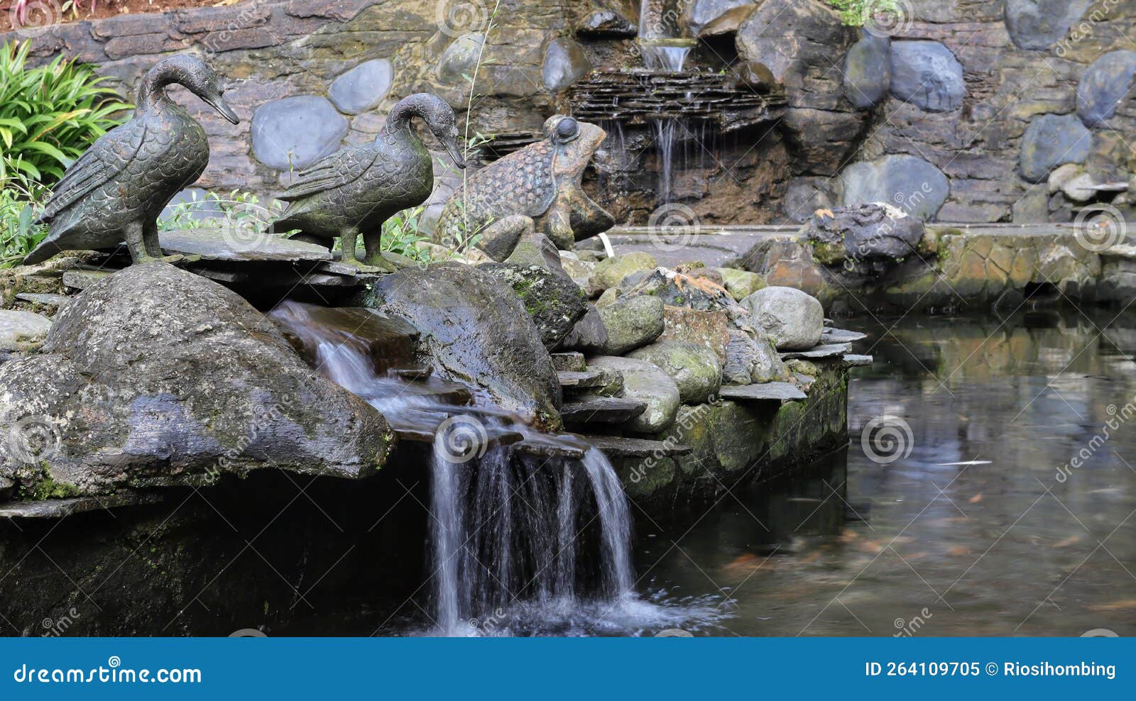 A Rocky Pond with a Mini Waterfall with Some Animal Statues Stock Image Image of outdoors