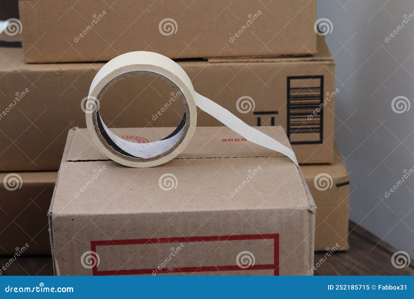 A Roll of Adhesive Tape on a Cardboard Box Stock Image Image of