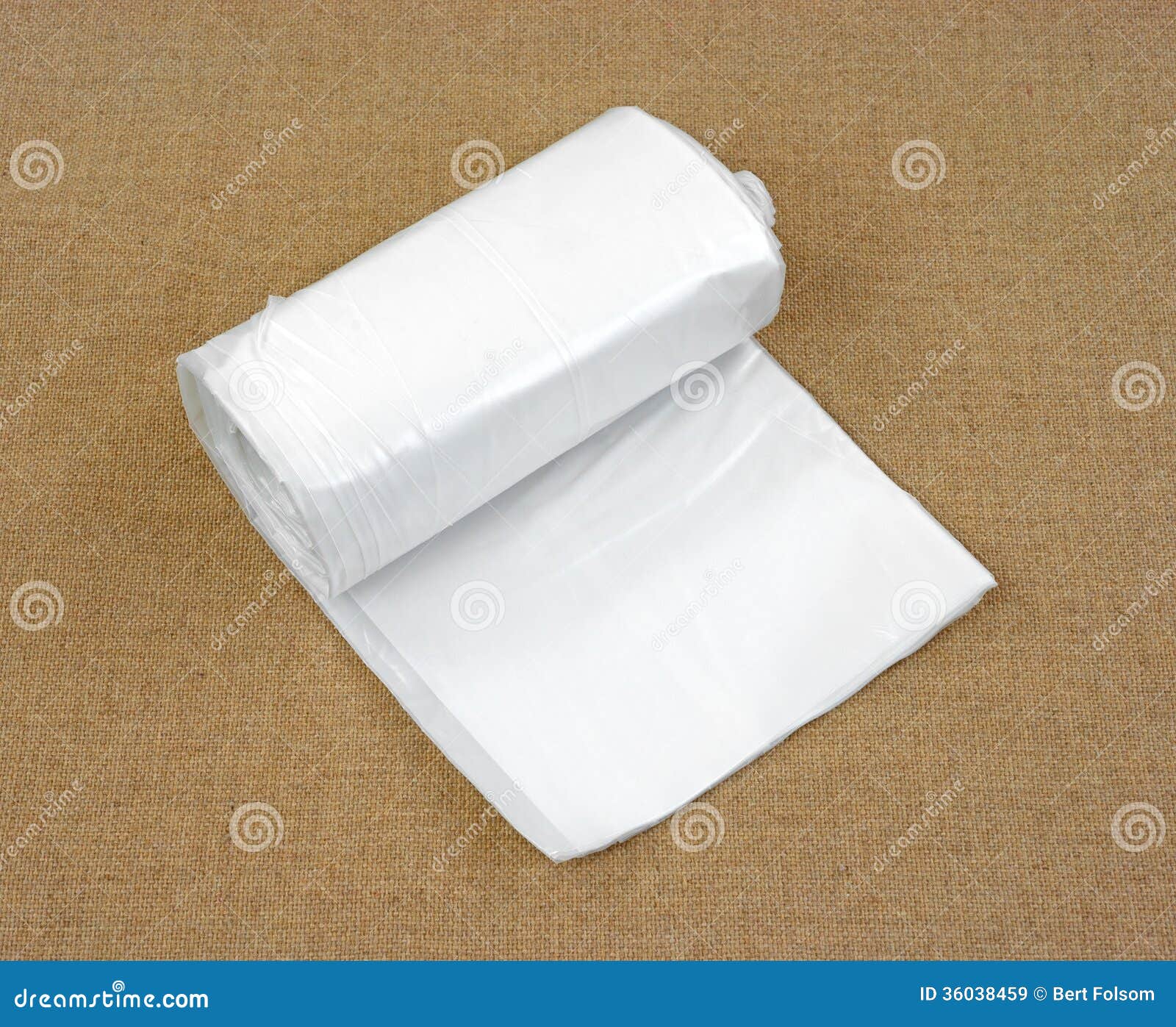 Roll of Plastic Sheeting on a Tan Background Stock Image - Image of