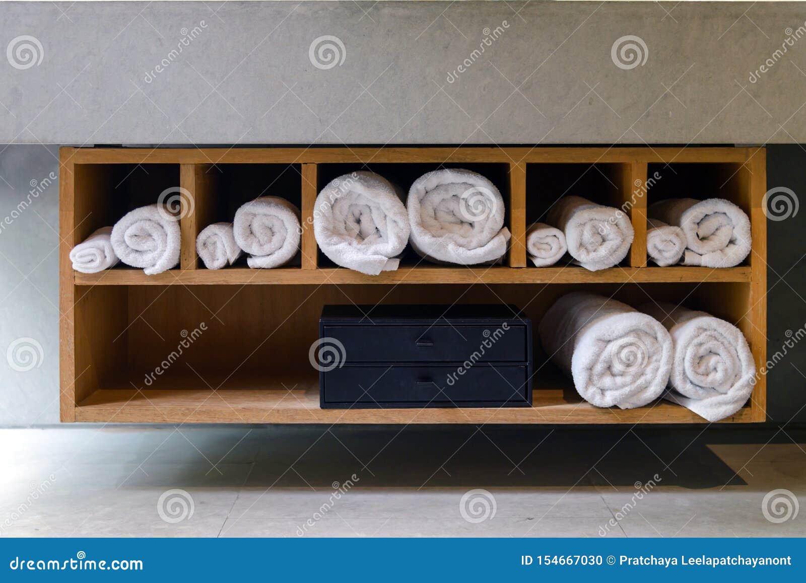 Roll White Soft Towels In Built In Wooden Shelf Stock Photo