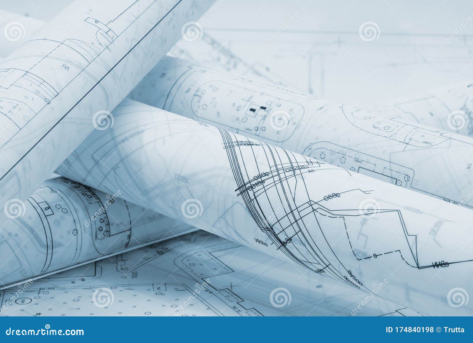 rolled architectural plans lying on drawing board