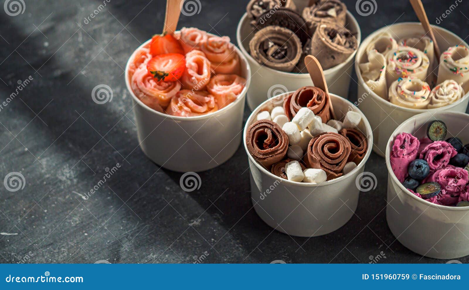 rolled ice creams in cone cups on dark background