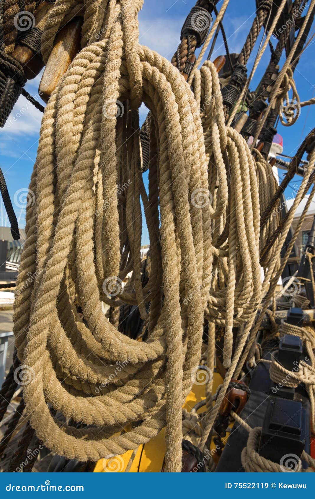 Rolled Thick Ropes on the Old Ship Near Wooden Cleats Stock Image