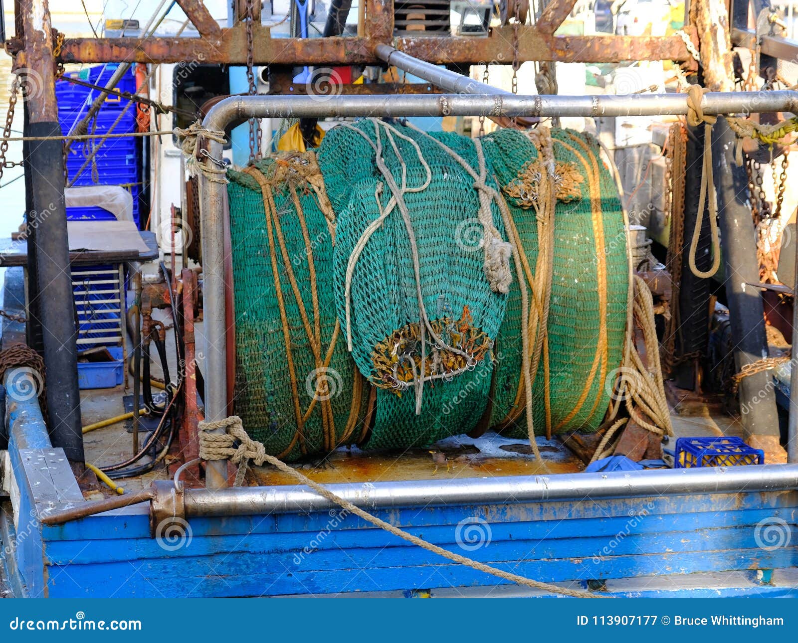 Rolled Up Green Fishing Net on Deep Sea Trawler Stock Image
